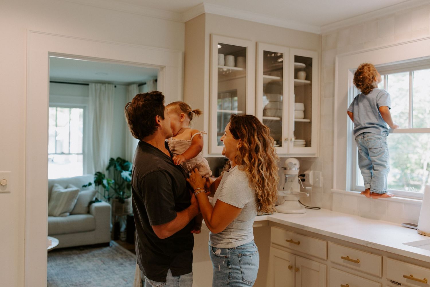 A warm embrace captured in a bright, modern kitchen interior.