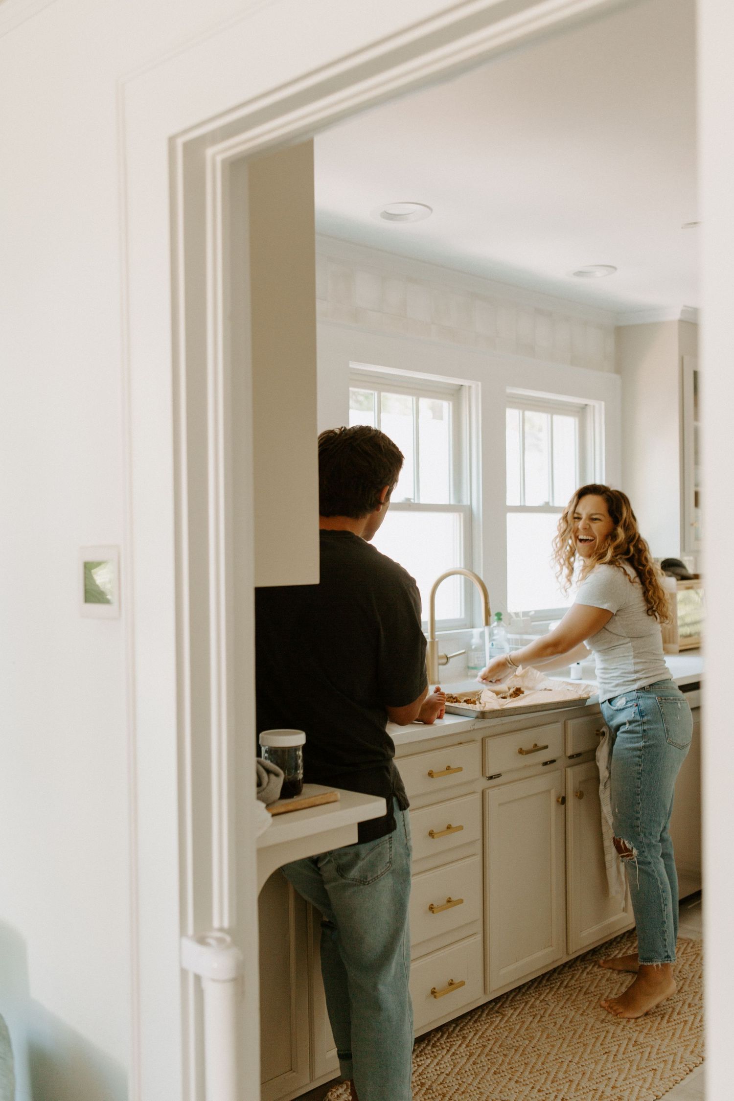Family members working together at white kitchen counter.