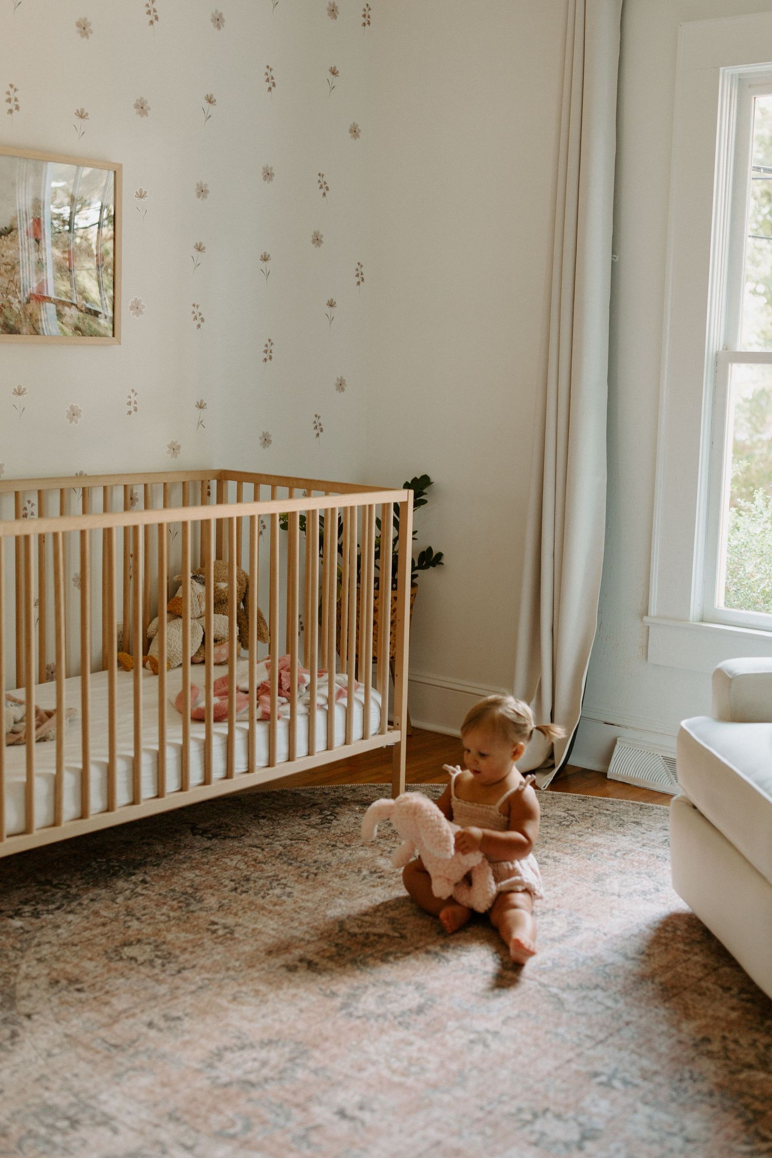 A series of photos showing a wooden crib and teddy bear in a nursery room with polka dot wallpaper and natural lighting.