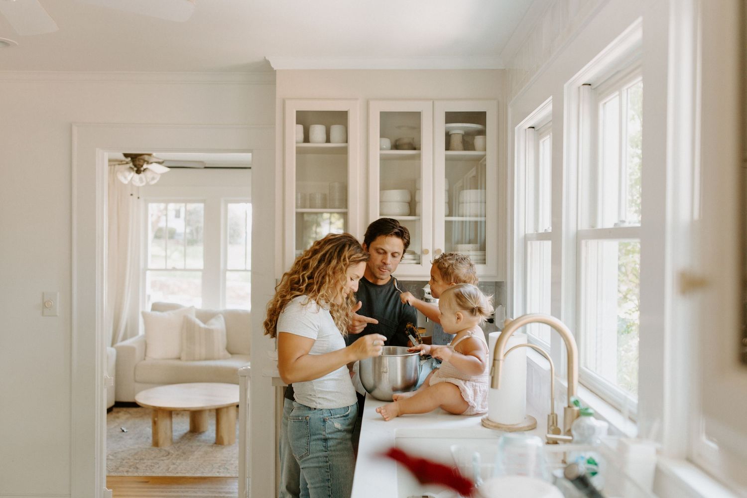 A series of candid moments in a bright white home interior showing daily life and intimate family interactions.