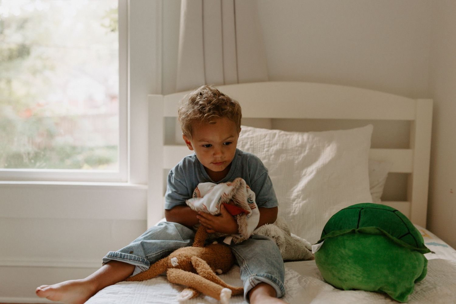 Playful movements photographed in a bright, airy bedroom with white furnishings.