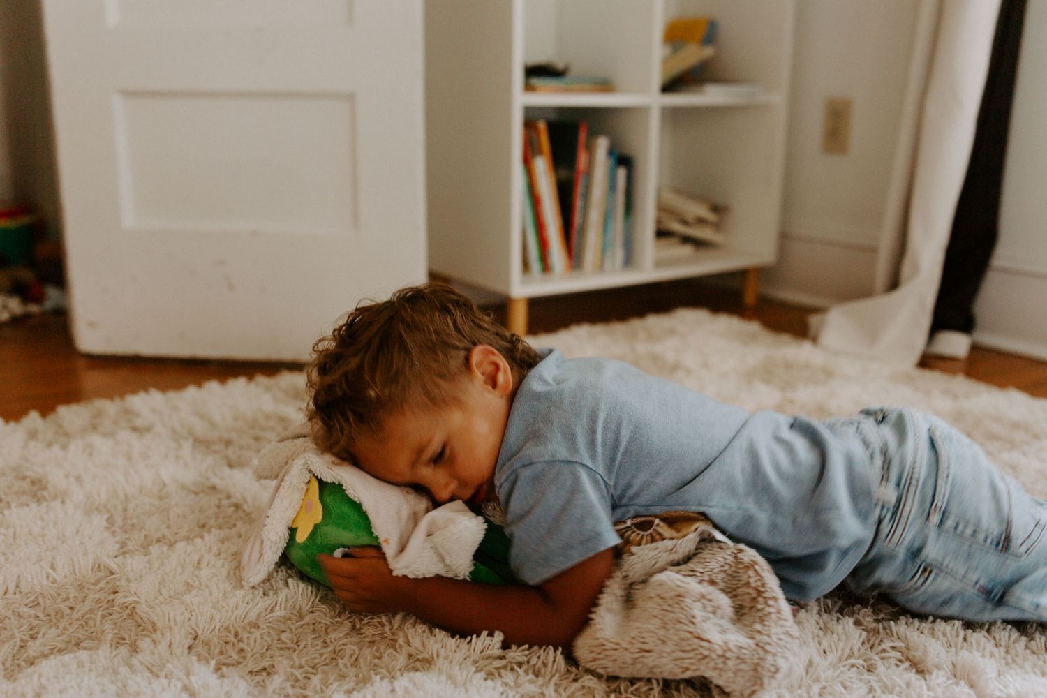 Cozy moments on a plush white carpet in a naturally lit bedroom.