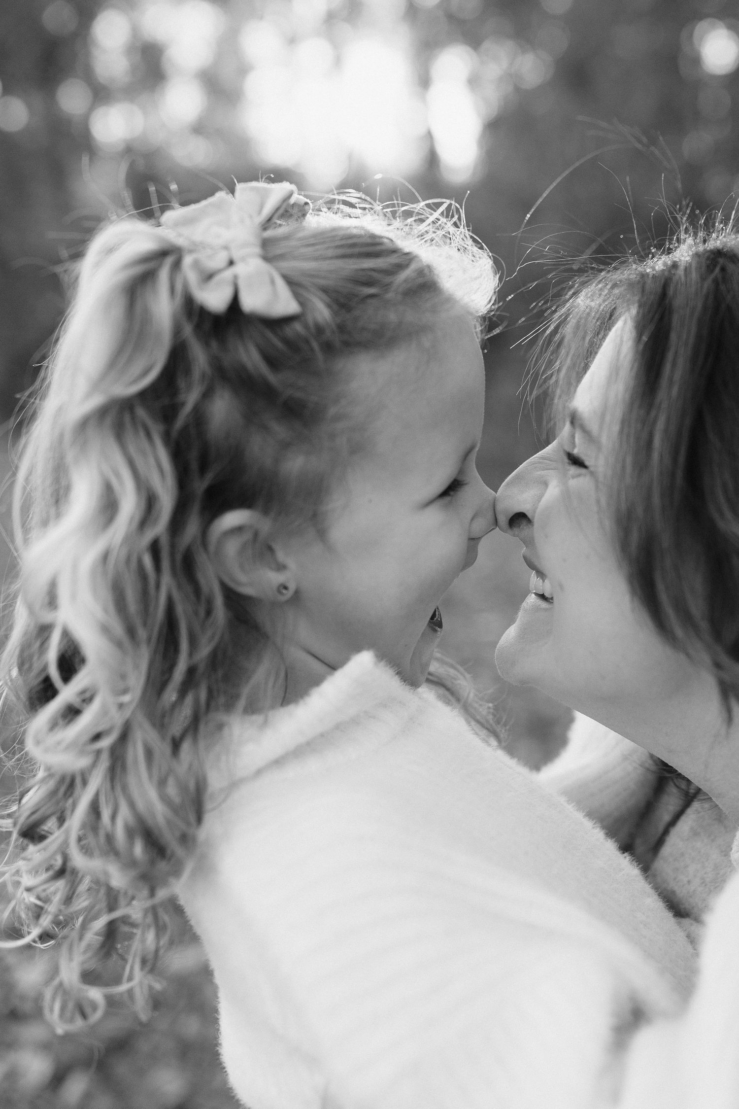 Black and white close-up photo of a tender moment between two people sharing affection.
