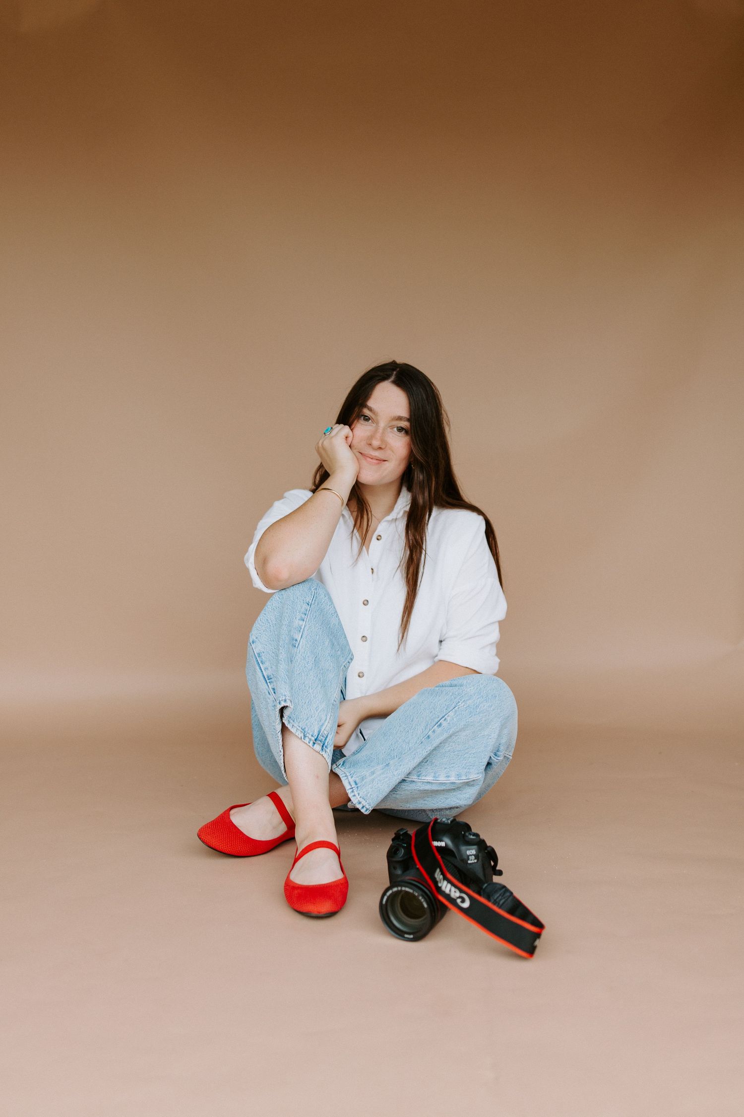 Artistic fashion photo series with red shoes and casual outfit against beige background.