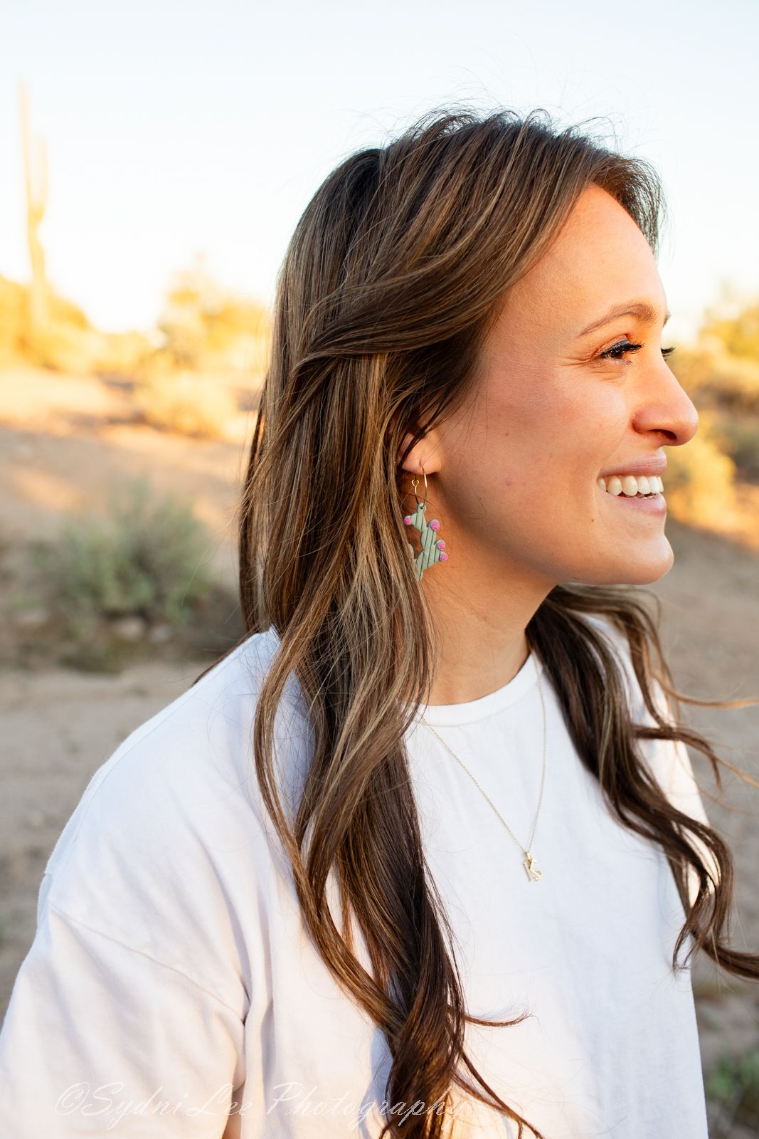 Side profile portraits showing a person in white top with brown hair against a bright desert backdrop.