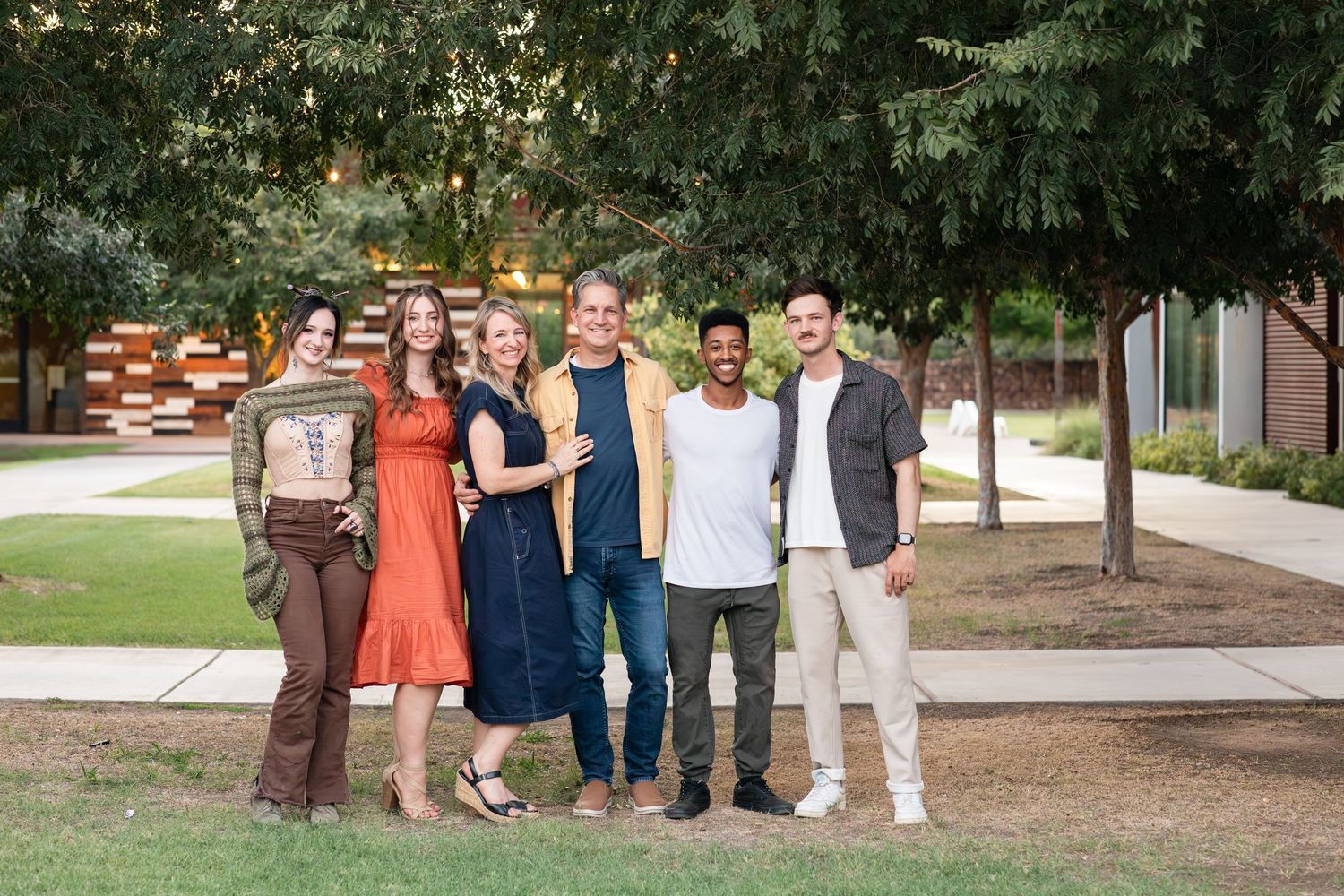 Large group photo of people gathered outdoors on a sunny day.