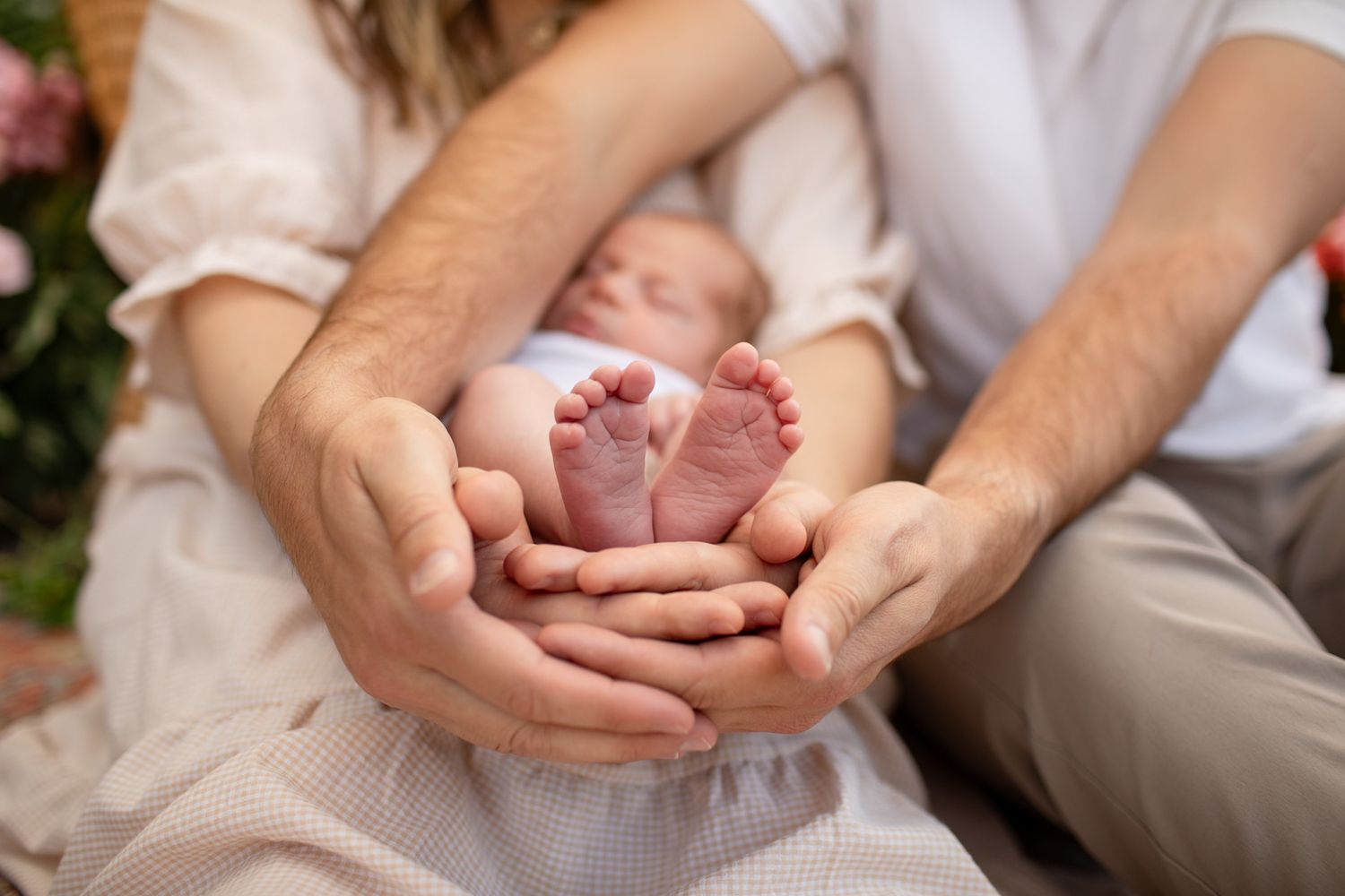 Close-up shots of tiny newborn baby feet being gently held in adult hands at The Moody Greenhouse in Mesa, Arizona.