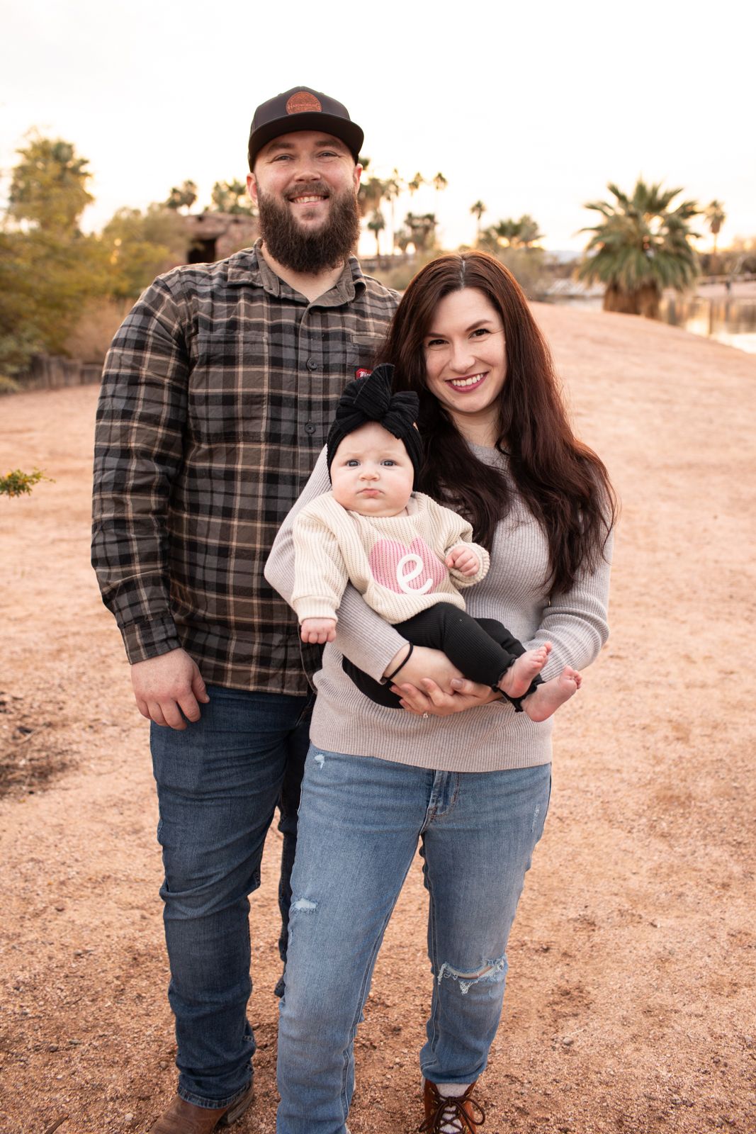 A casual outdoor family portrait session featuring plaid and denim outfits in a desert landscape in Papago Park in Phoenix, AZ.