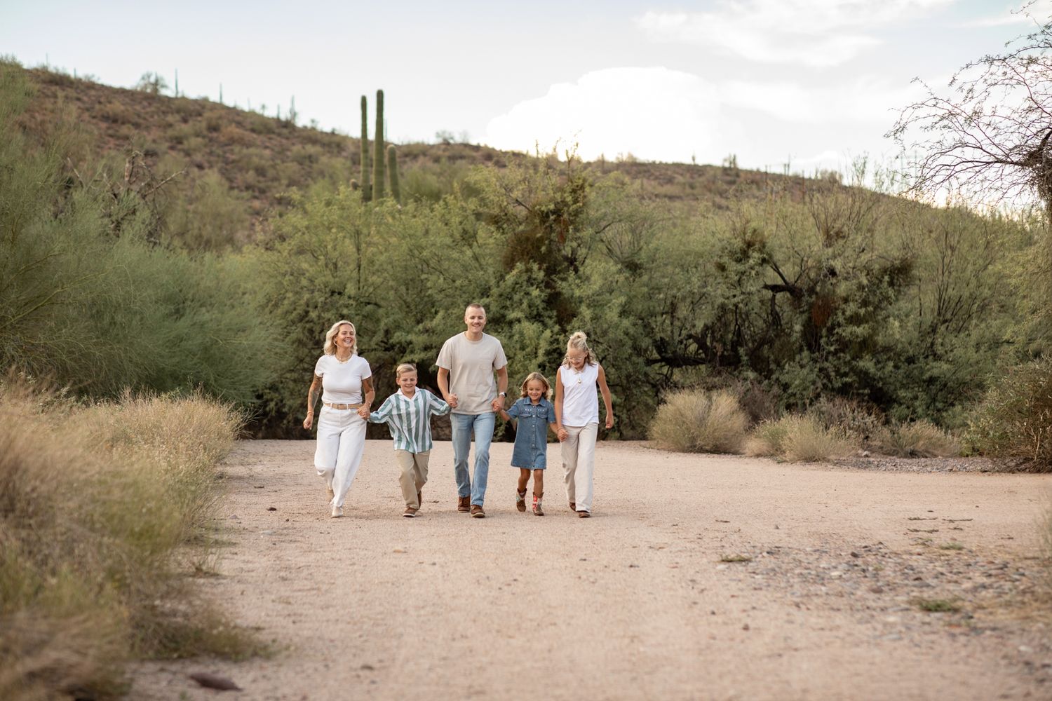 Desert landscape family portraits showing people walking together against mountain backdrop at Water Users recreational area.