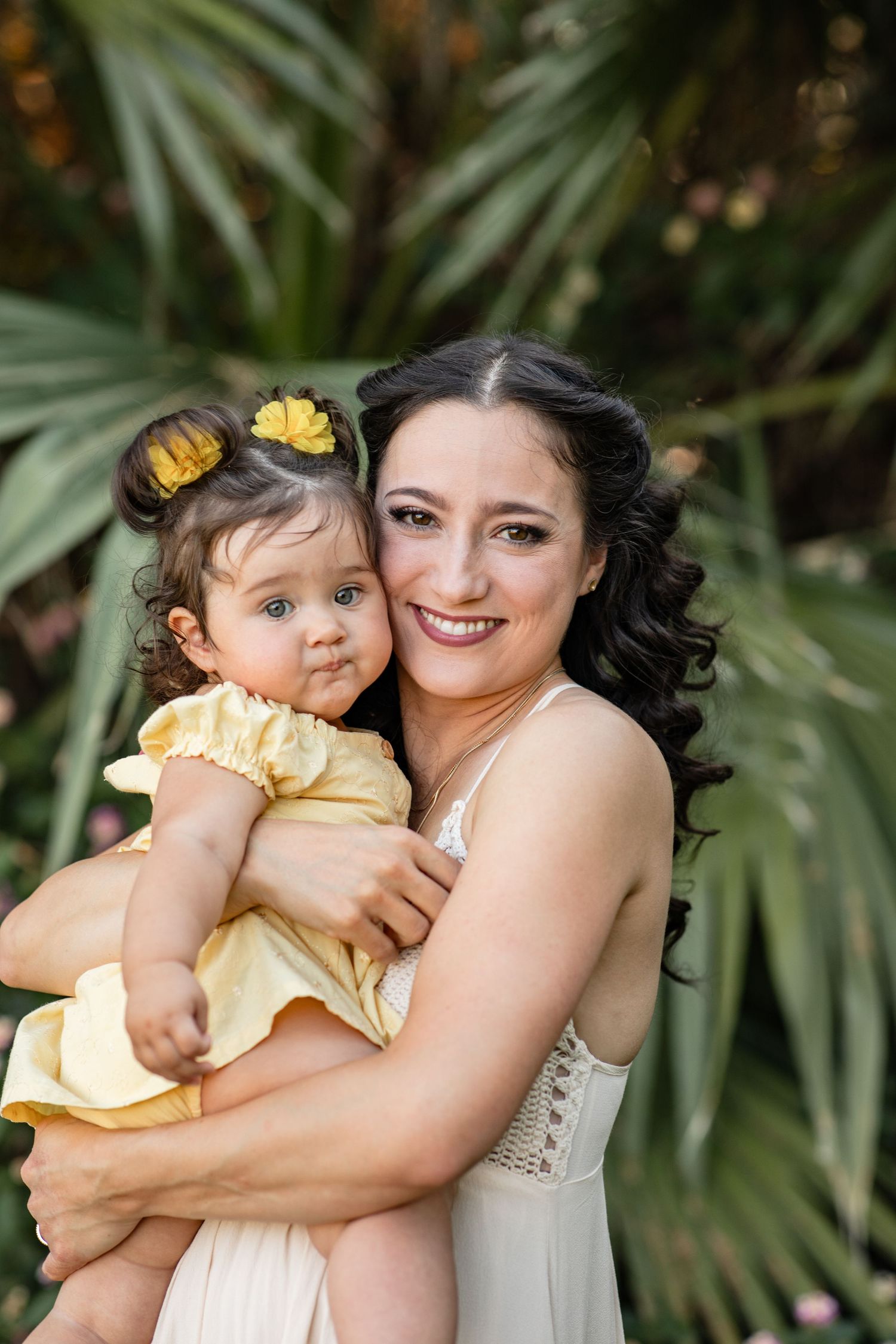 A tender moment captured in a series of photos showing loving embraces against a lush tropical plant background at The Meadow in Mesa.