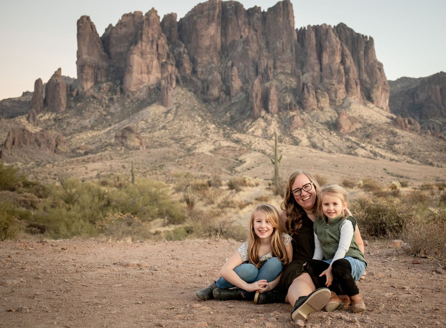 A scenic desert landscape with dramatic rock formations and mountain peaks in the background at Superstition Mountains, Arizona.