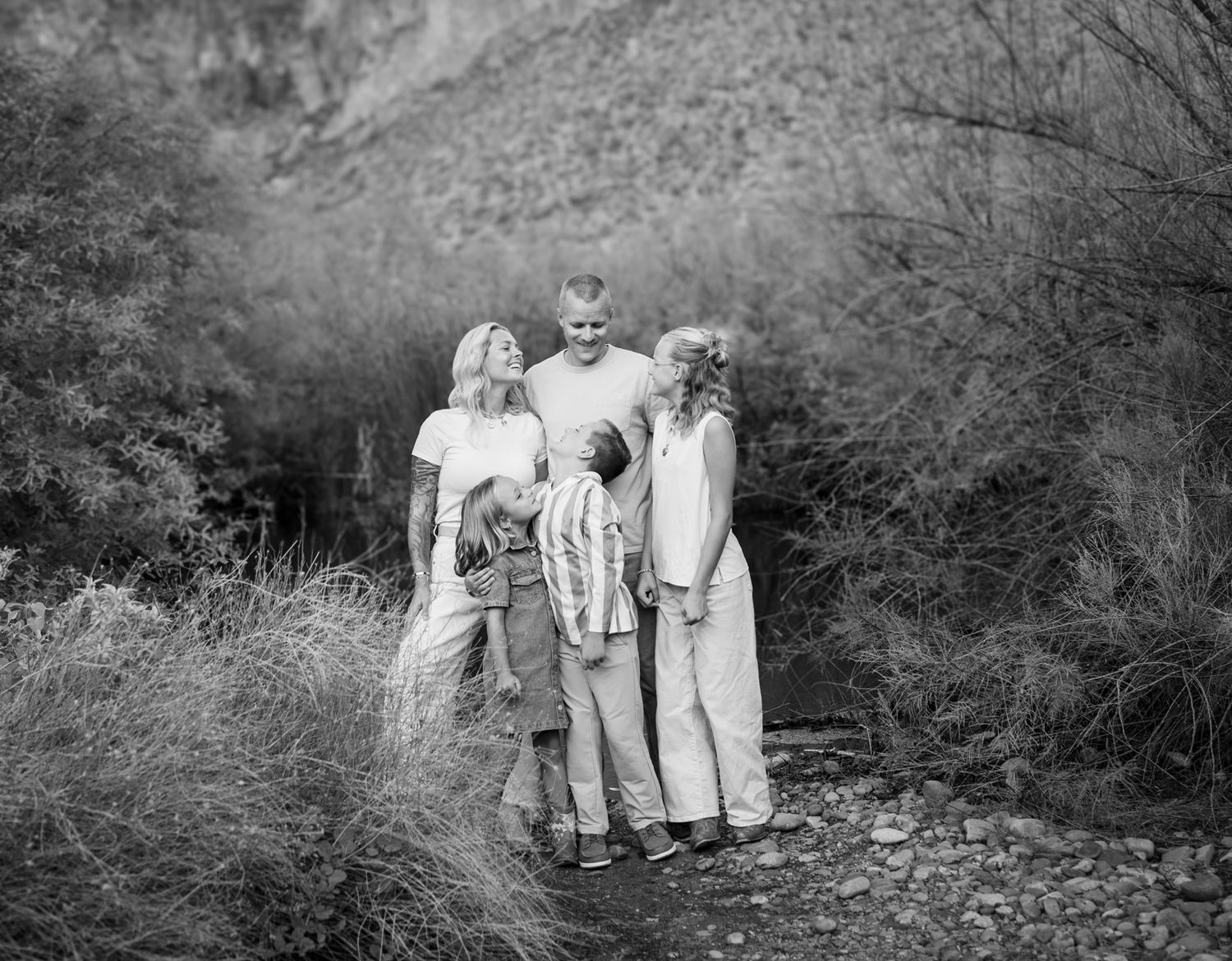 A series of black and white photographs showing people walking together through a wooded outdoor setting at Water Users recreational area.