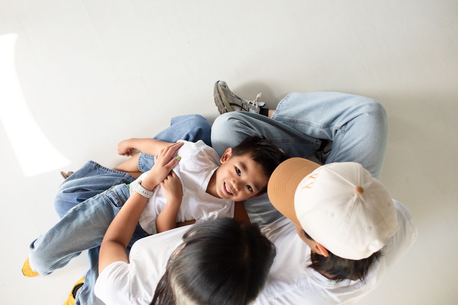 Casual lifestyle photos showing playful moments against a white studio backdrop at Letty Lume studio in Gilbert, Arizona.
