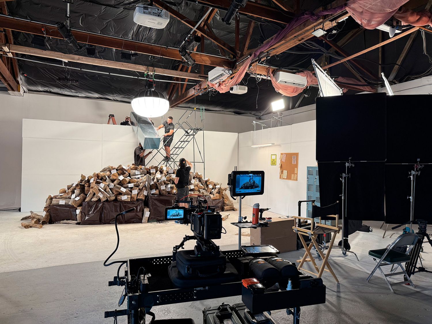 Interior views of a professional television or film studio with lighting fixtures, cameras and production equipment.
