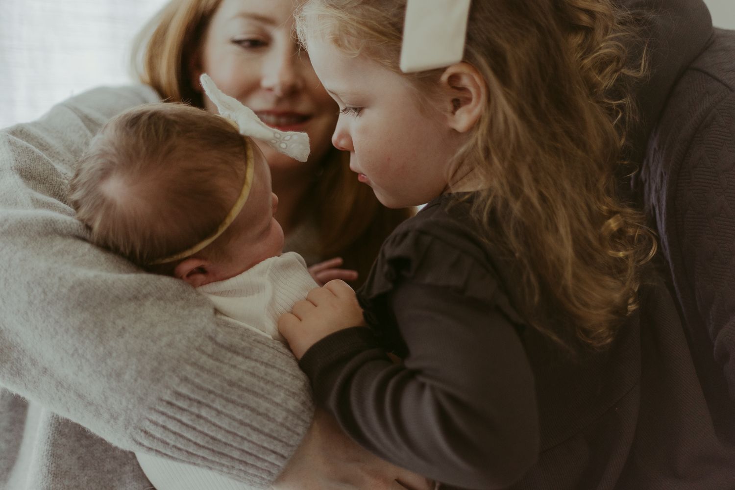 Tender moment shared between family members in a cozy indoor setting.