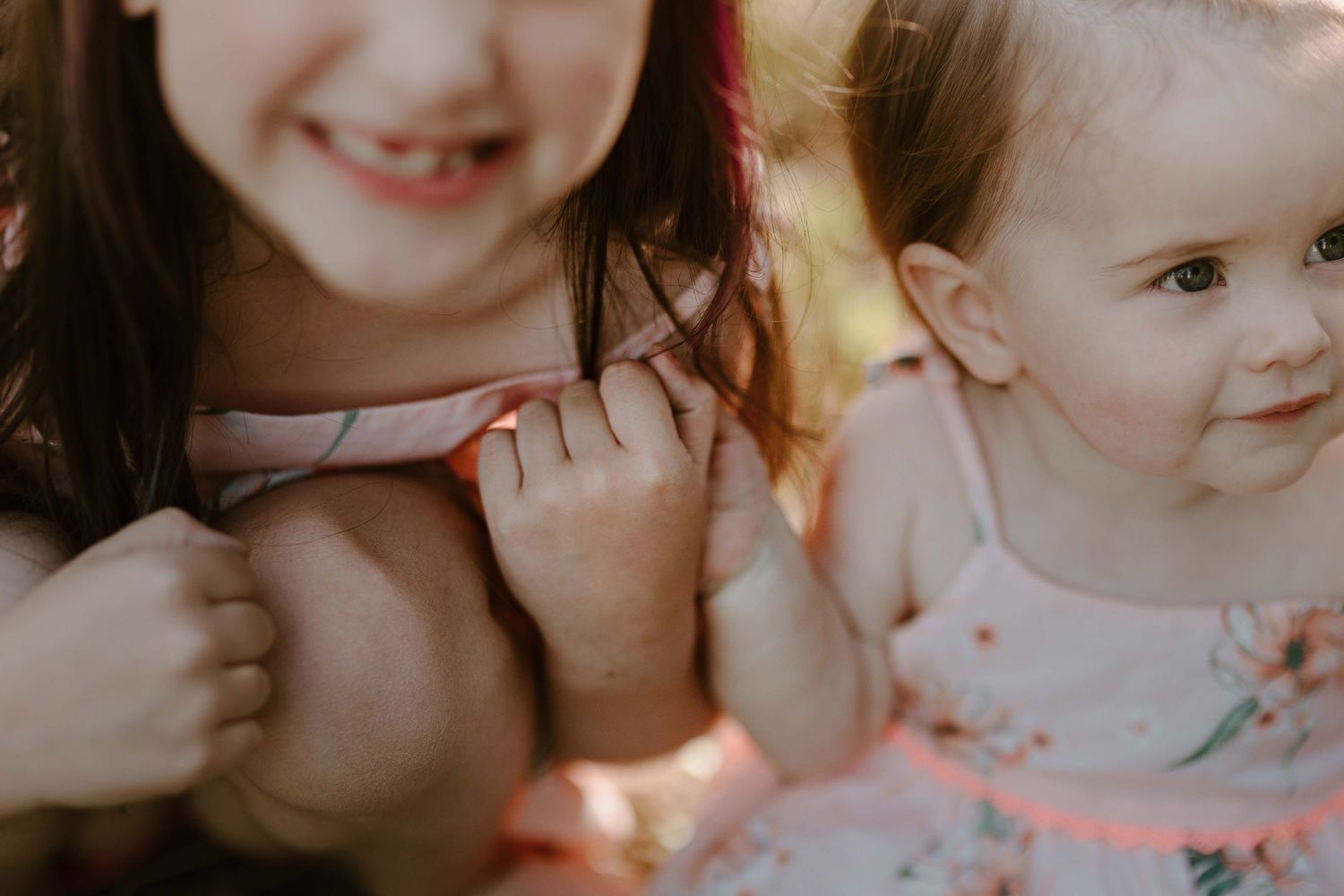 Close-up portrait of joyful expressions in warm lighting.