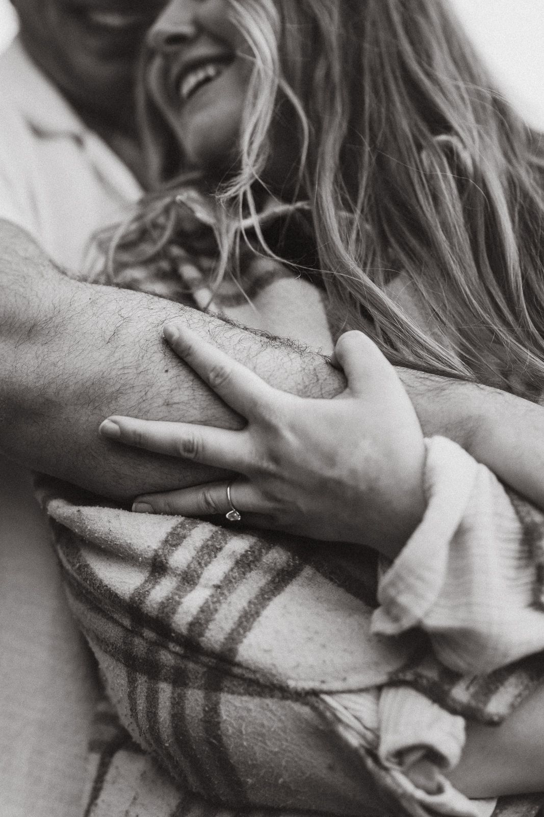 Artistic photo showing hands in black and white, in an intimate moment.