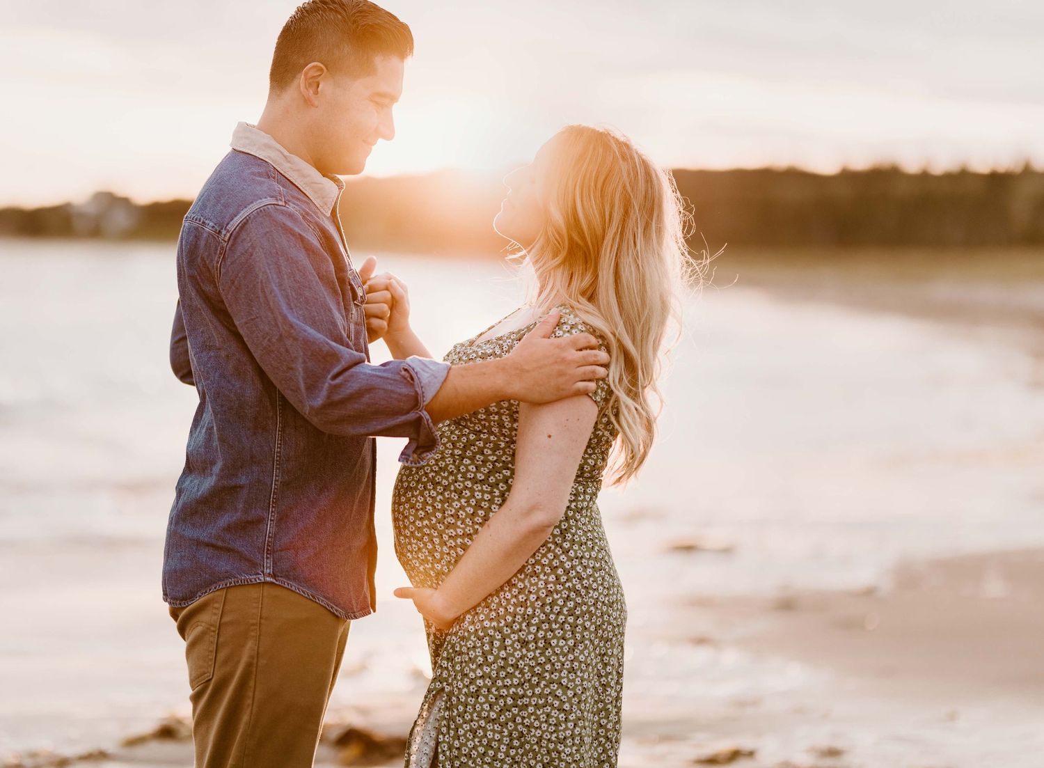 Sunset maternity session shows tender moments between couple on beach.