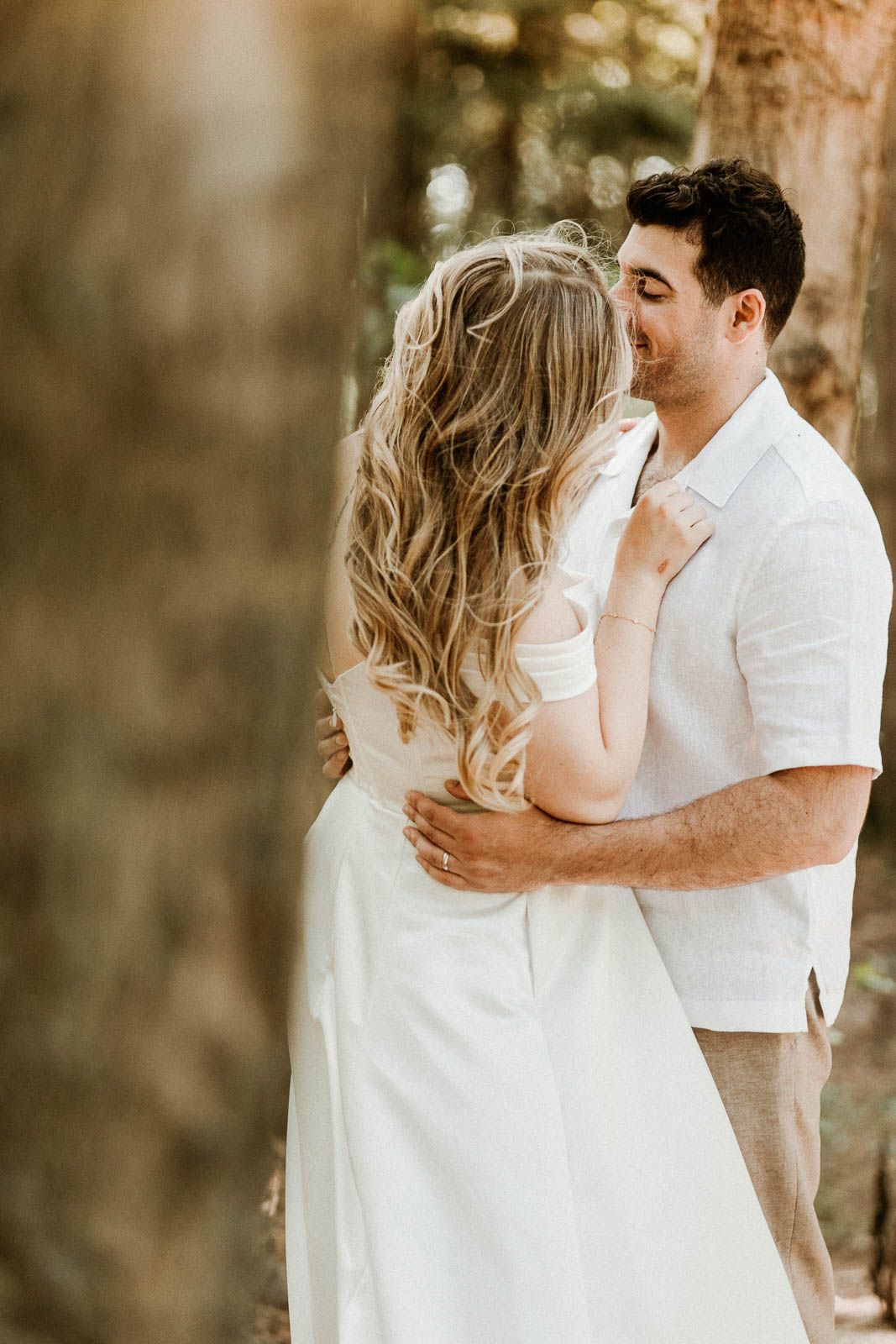 A romantic wedding photoshoot showing tender moments between newlyweds in white and cream attire.