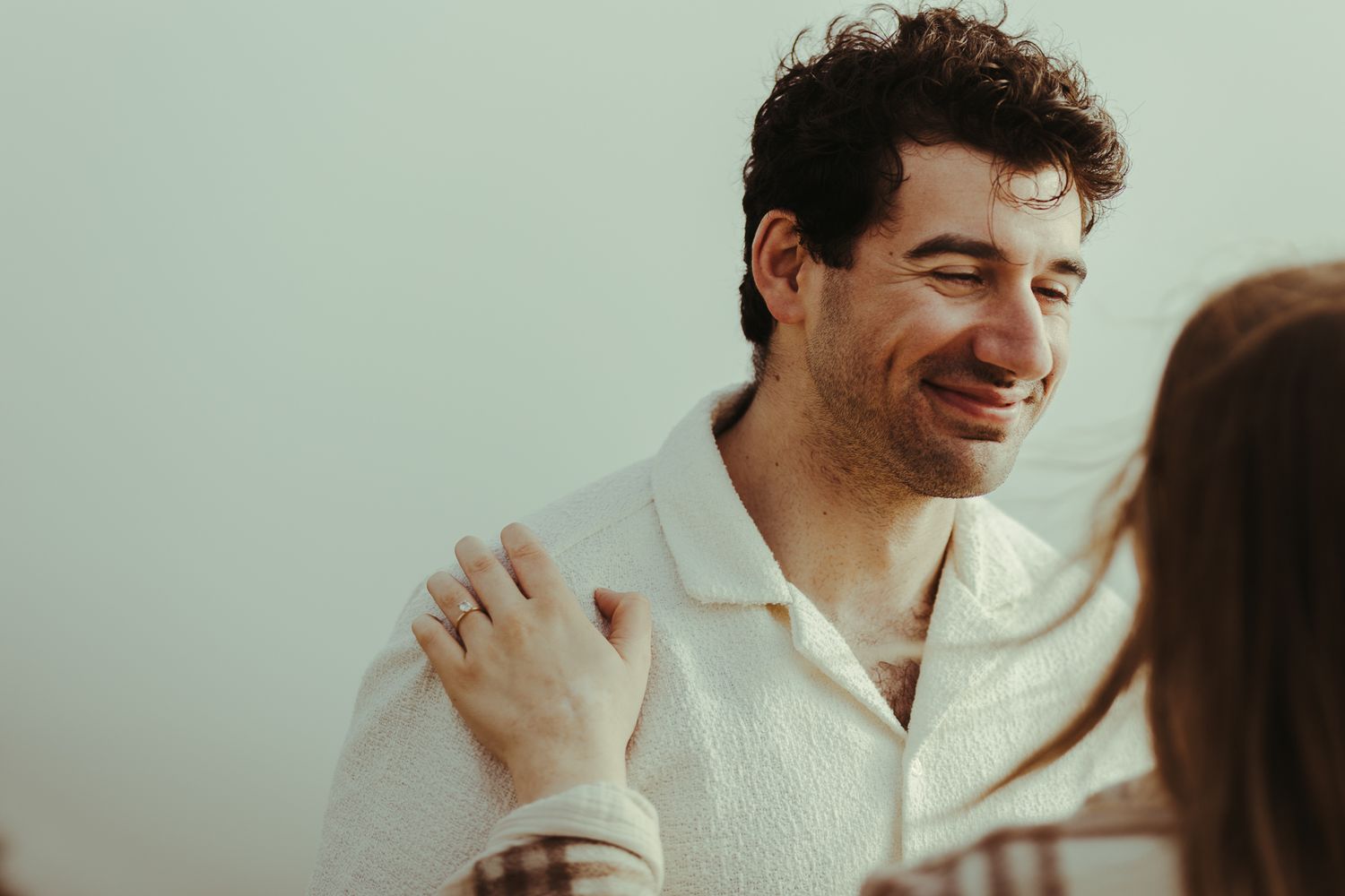 Natural candid moments showing laughter and joy during an outdoor photoshoot.