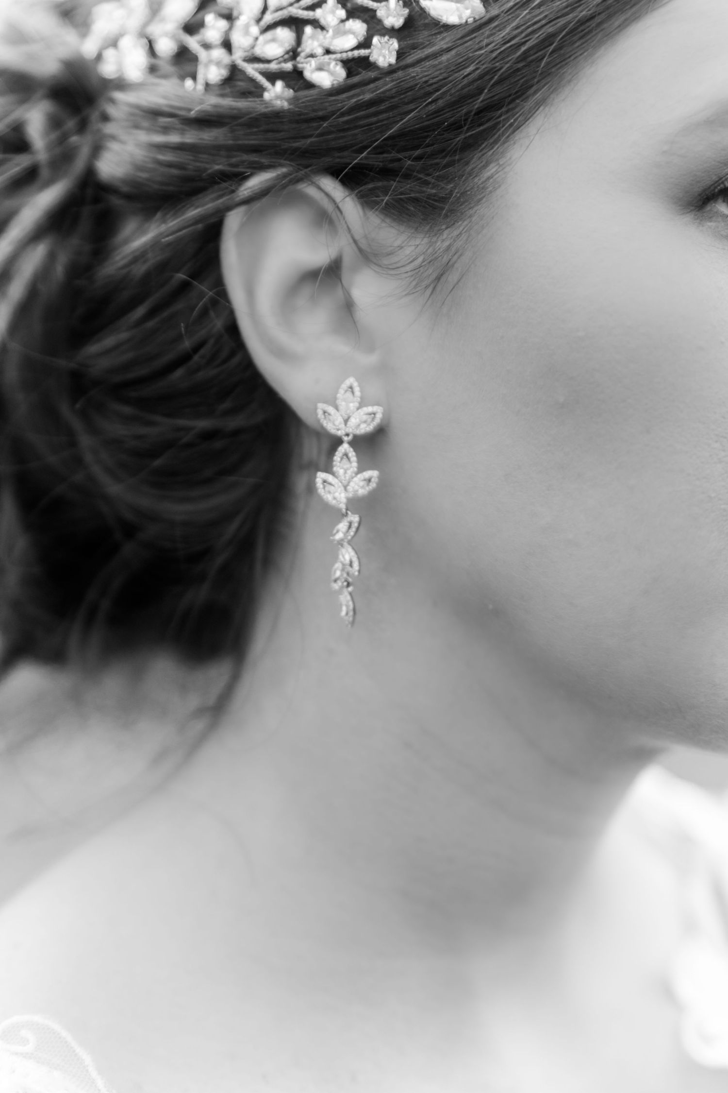 Delicate silver leaf-shaped earrings shown in a series of close-up profile shots.