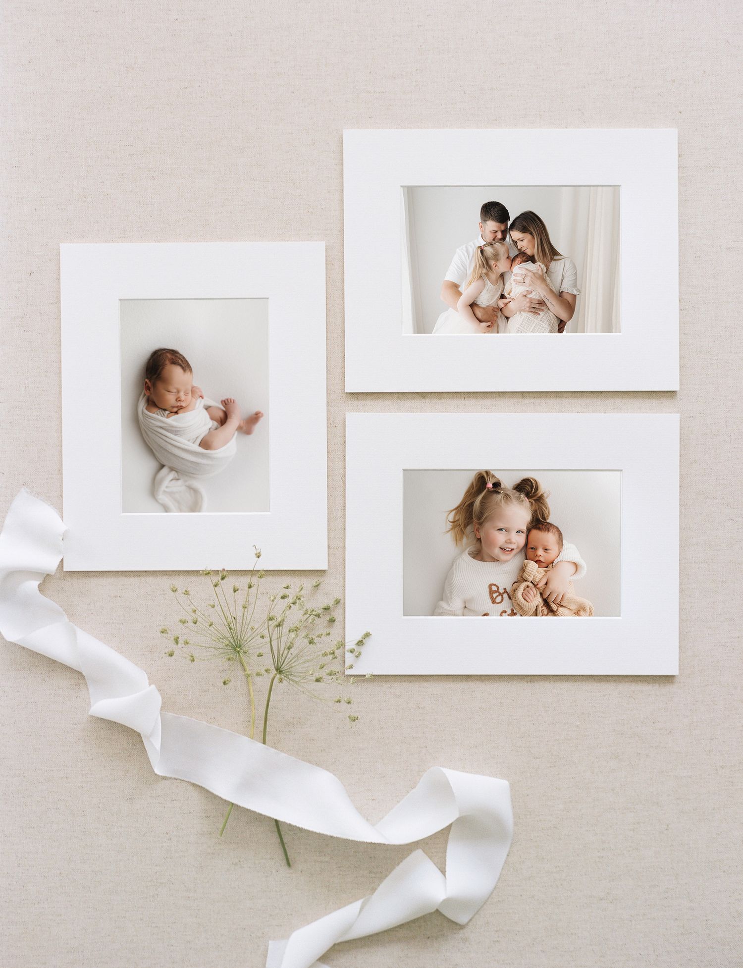 Minimalist photography layout with white frames, flowing silk ribbon, and delicate baby's breath flowers on beige background.
