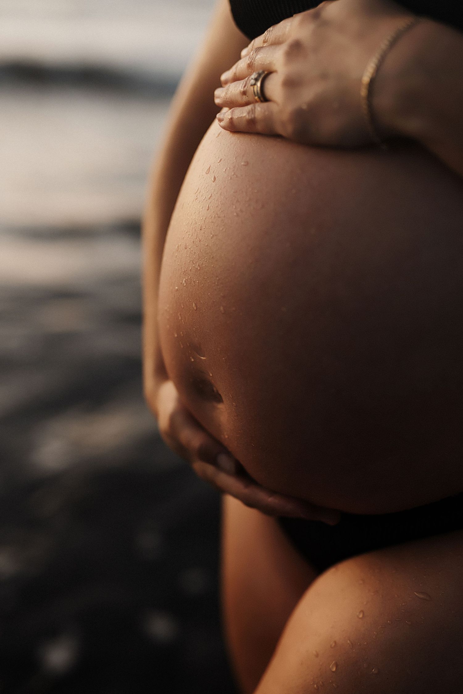 Six cropped photos showing a side view of a pregnant woman's growing belly in progressive stages of pregnancy development.