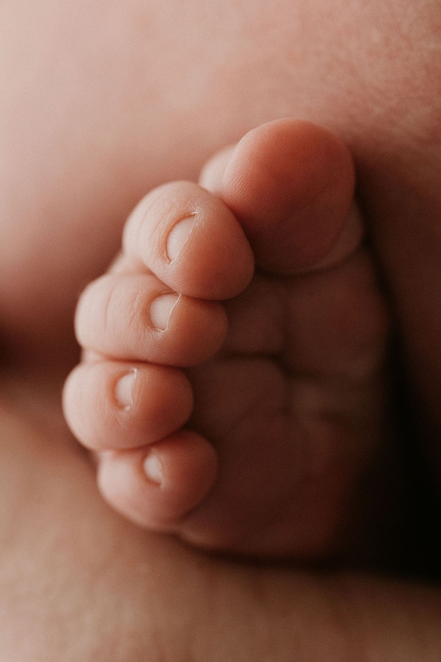 Close-up photo series showing tiny baby toes from different angles with soft natural lighting.