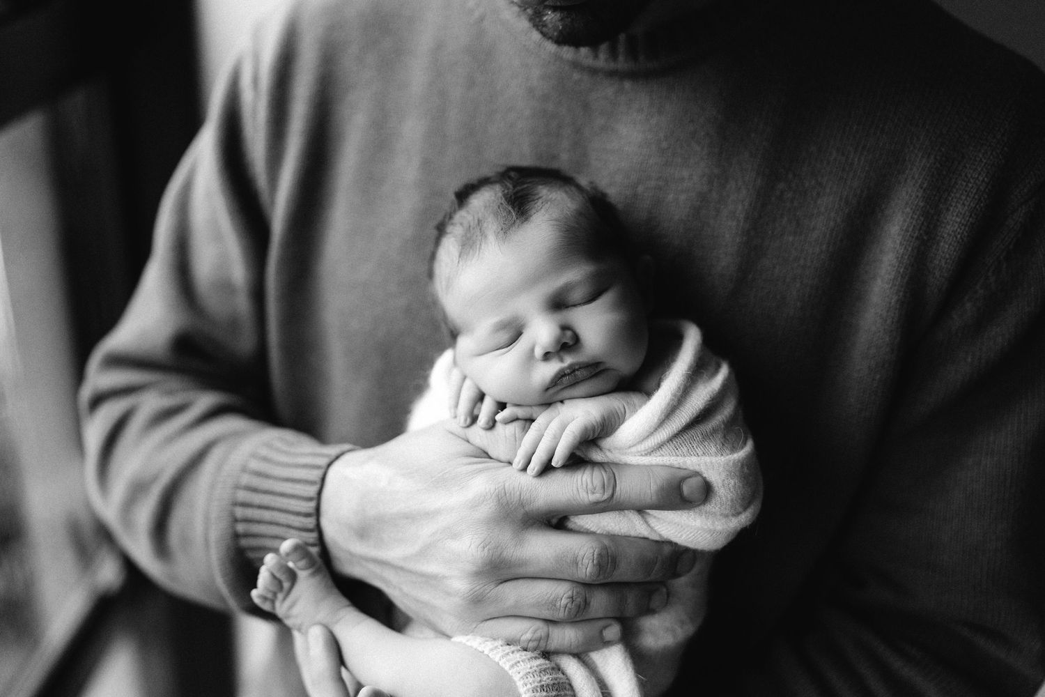 Black and white photo series showing tender moments between caregiver and a sleeping newborn baby.