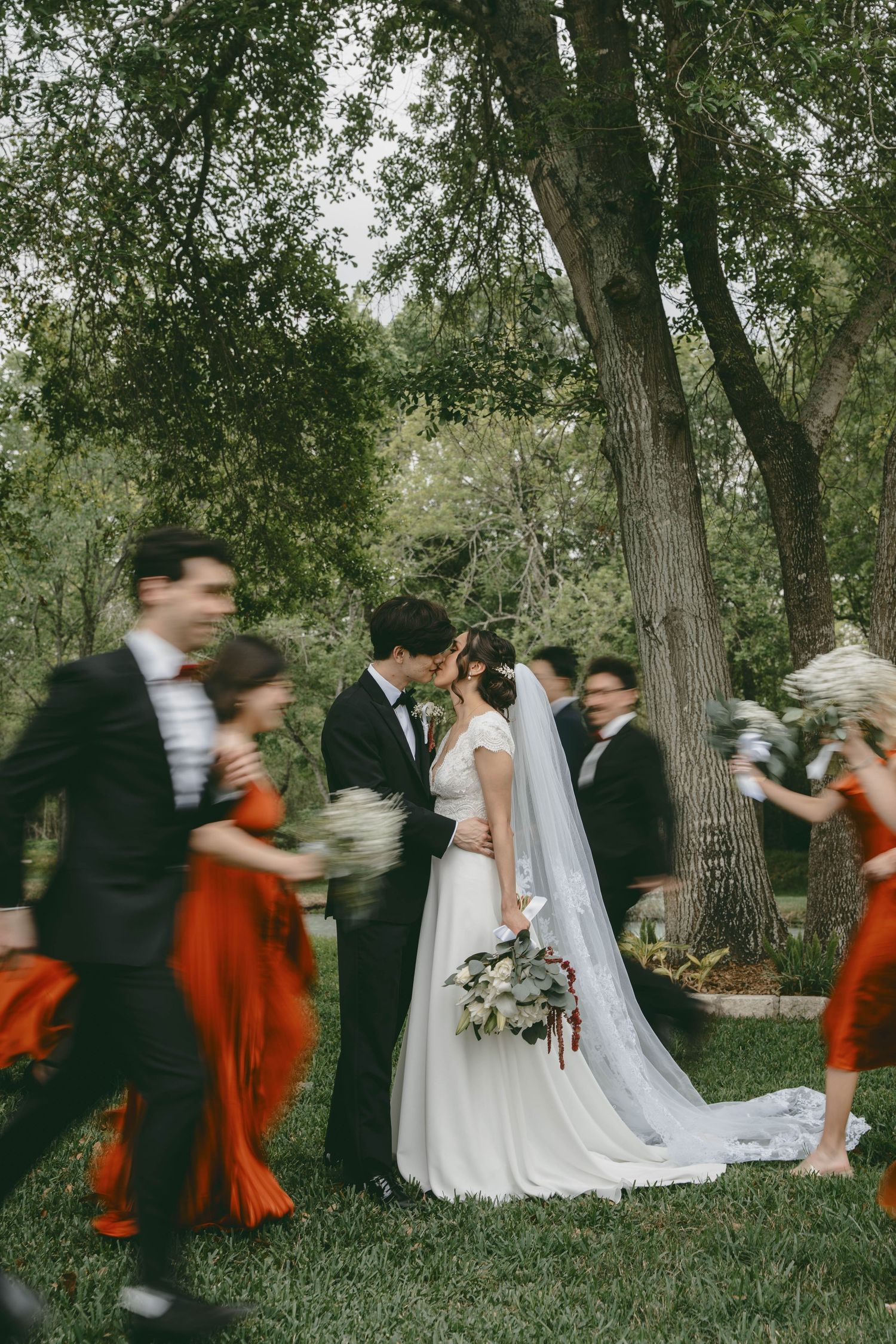 A sequence of motion-blurred wedding photos showing a couple and wedding party dancing through a wooded outdoor setting.