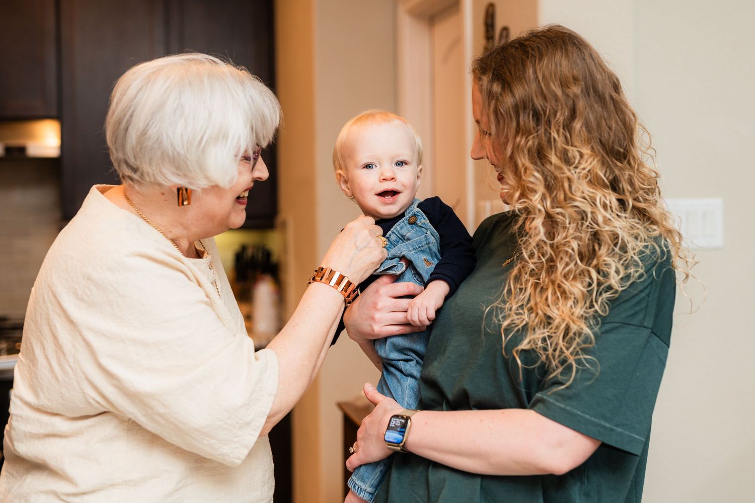 Heartwarming moment shared between three generations during indoor family gathering.