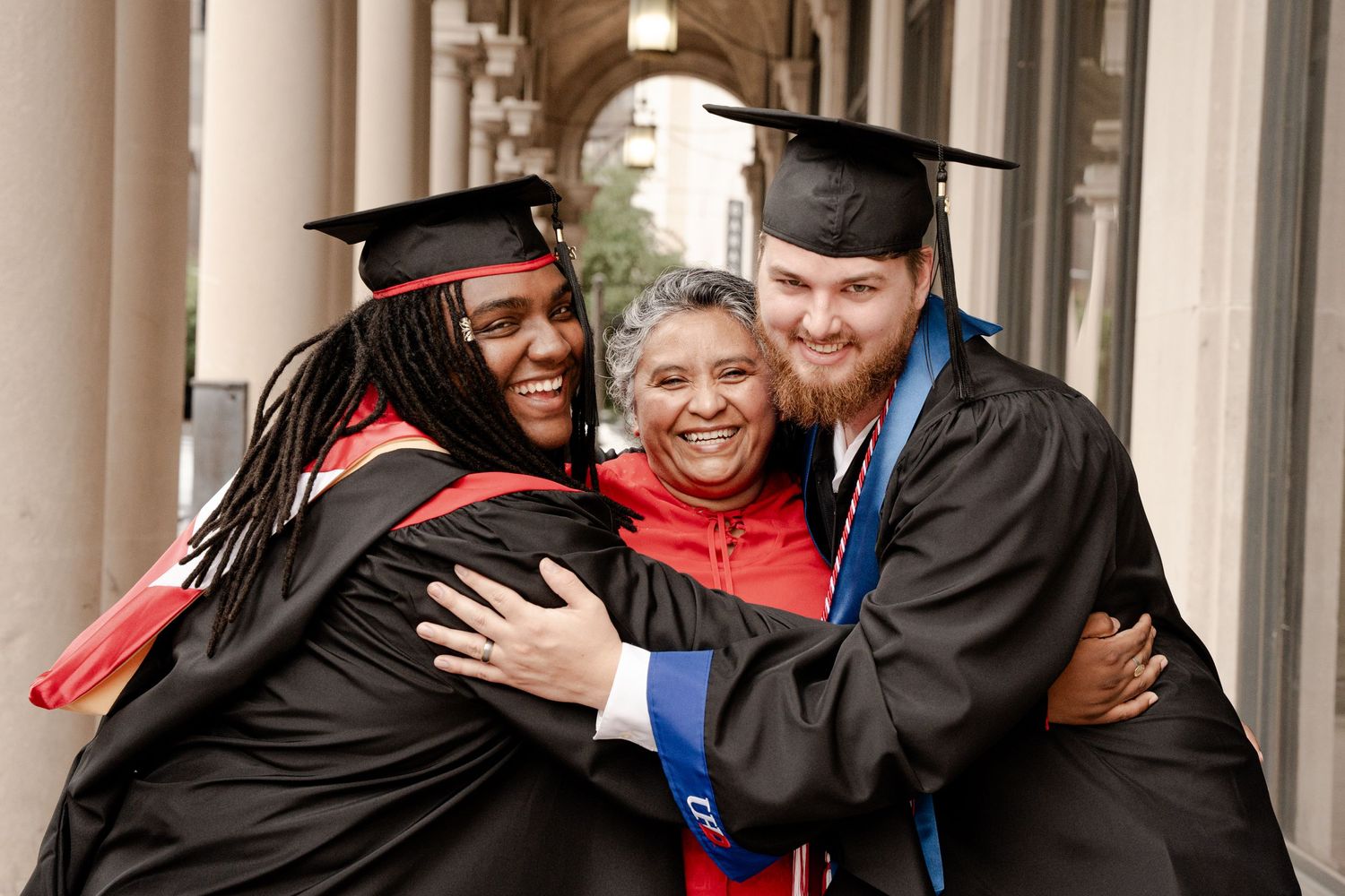 Graduates celebrate together in academic regalia during commencement ceremony.