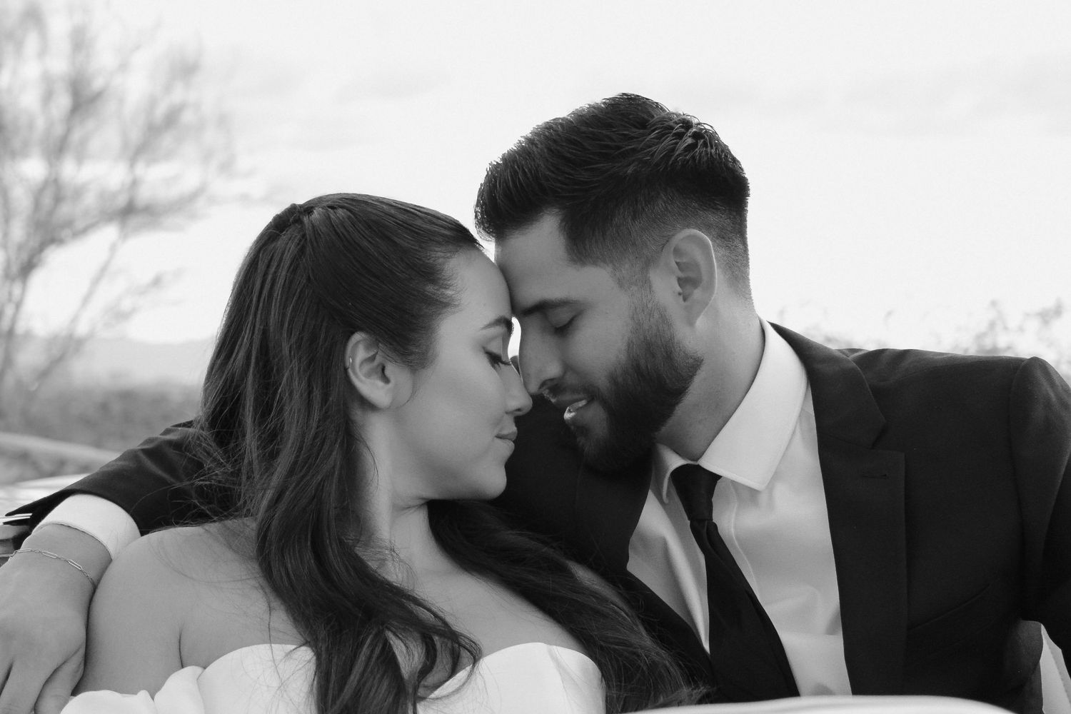 A romantic black and white close-up of newlyweds sharing an intimate moment.