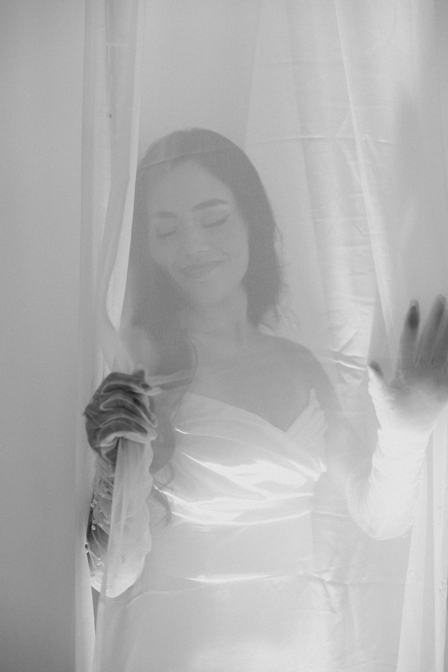 Tyler Garlej Photography - A series of dreamy black and white photos showing a person behind sheer white curtains in soft natural light.
