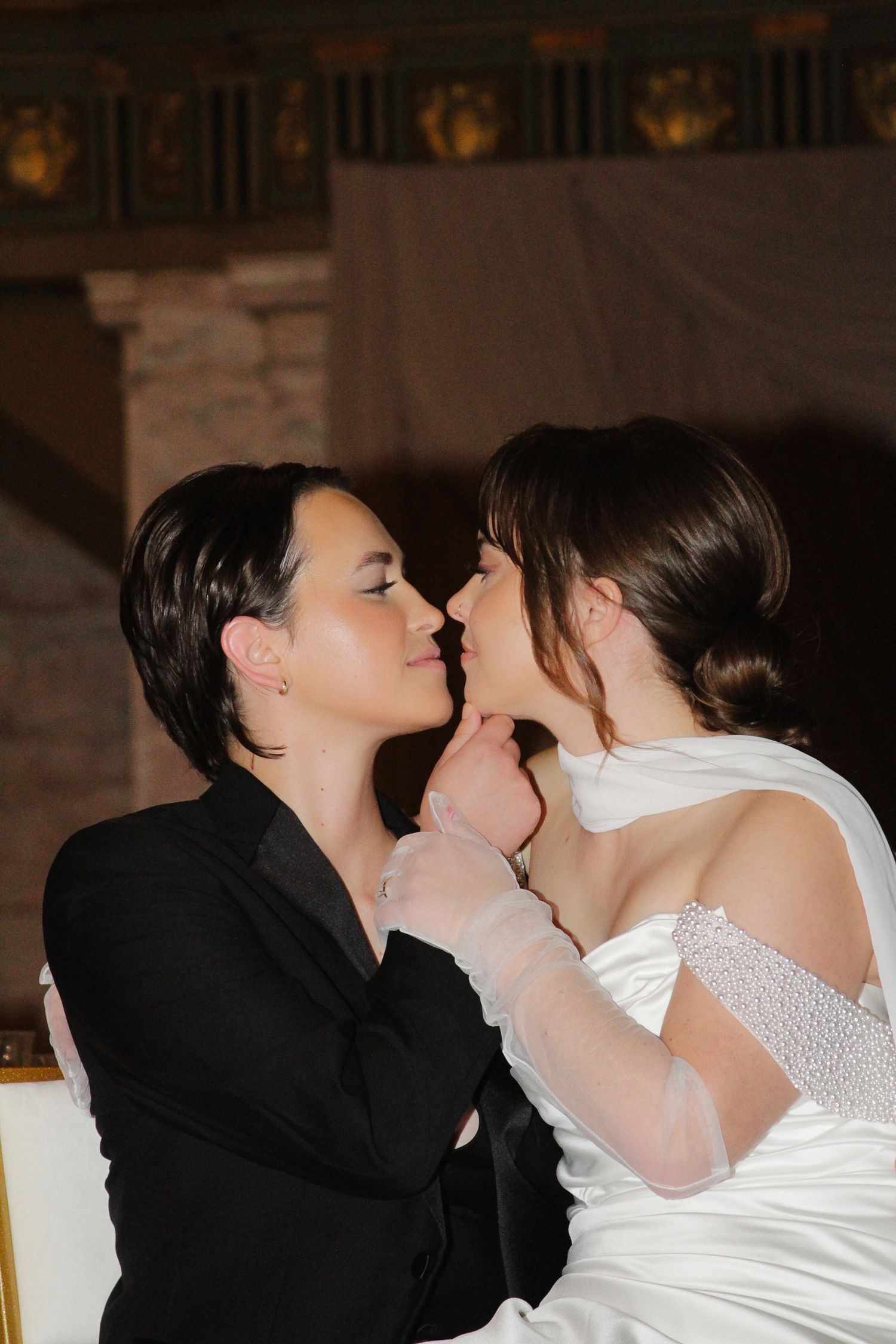 A romantic wedding moment captured between a couple in formal attire sharing an intimate kiss. Tyler Garlej Photography