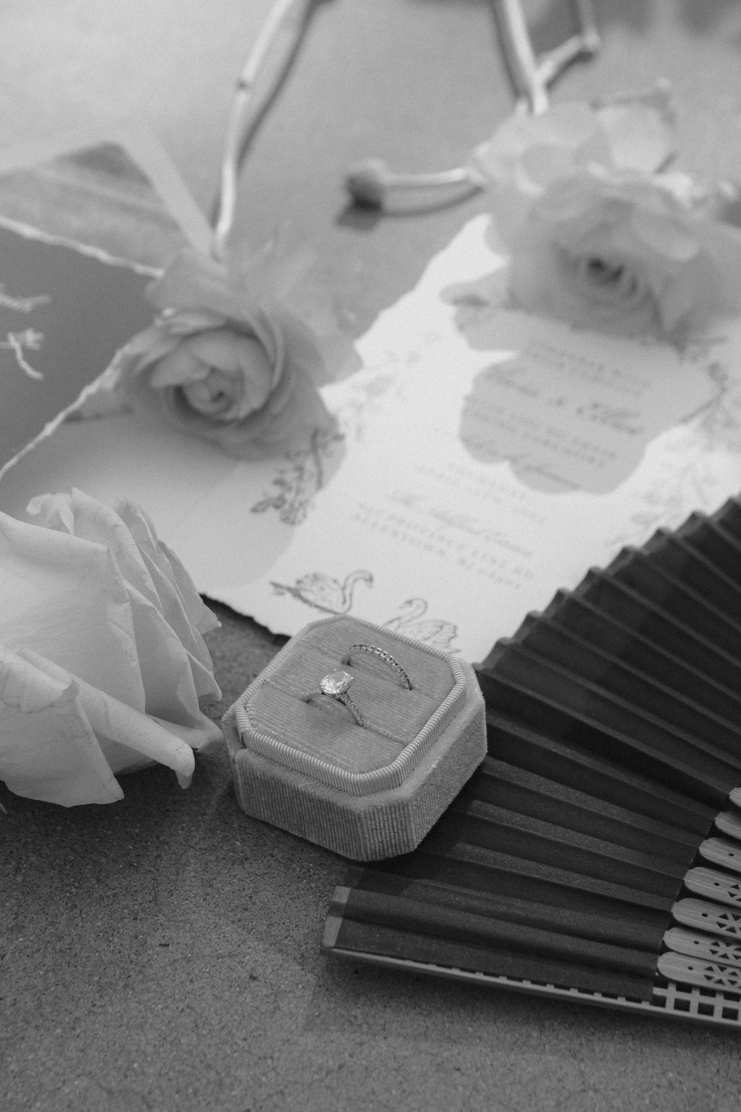 Black and white image of decorative paper fans with floral accents and ornate designs. Tyler Garlej Photography