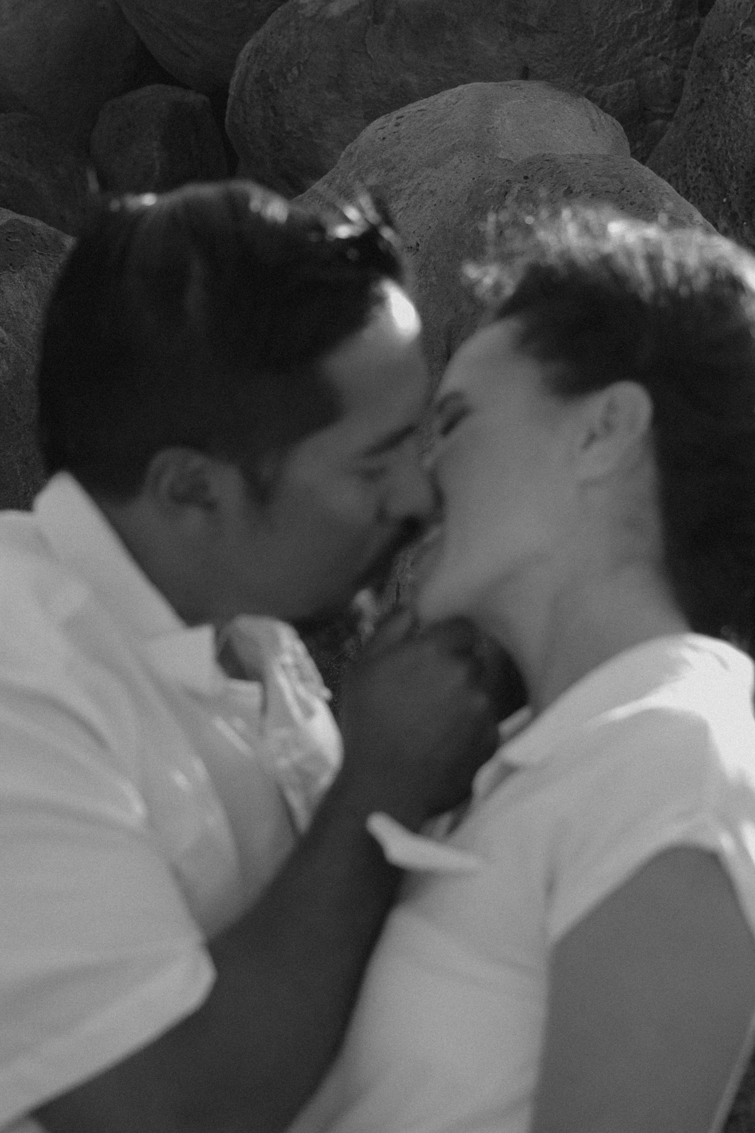 Black and white series of photos showing two people sharing an intimate kiss.