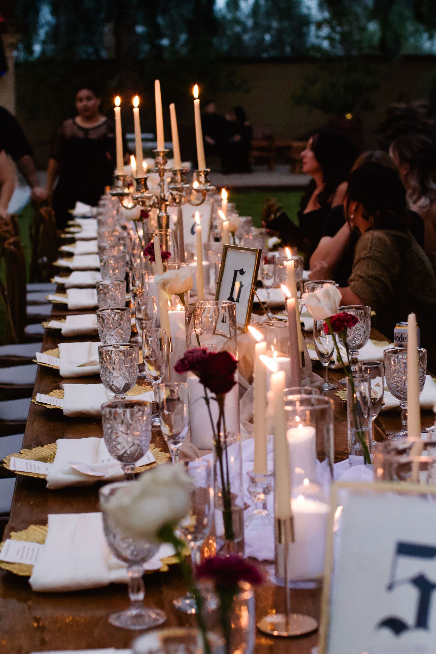 Elegant wedding reception table with crystal candelabras and white tapers creating romantic ambiance. Tyler Garlej Photography