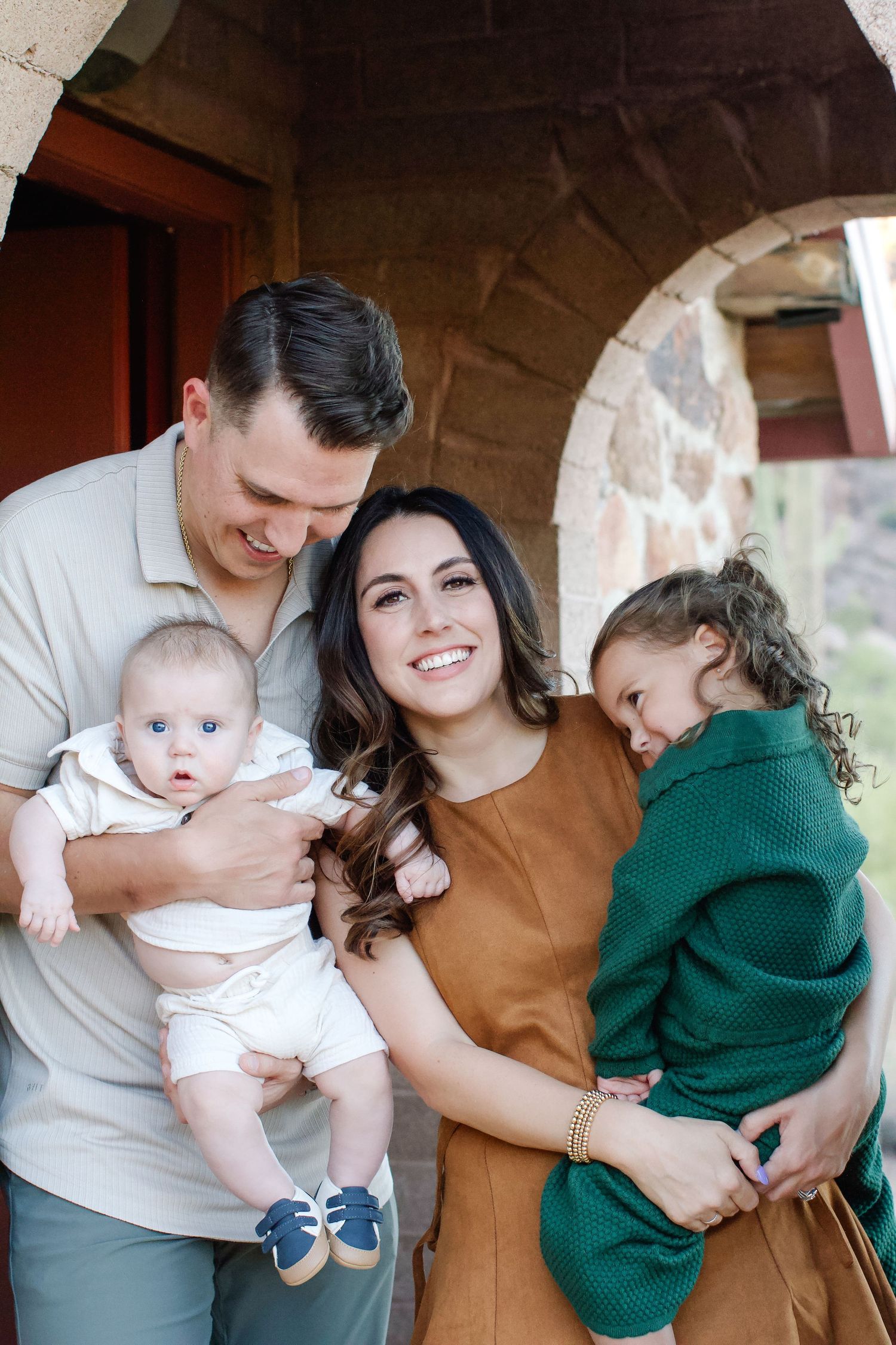 A series of four candid family photos showing tender moments between parents and baby in casual indoor setting.
