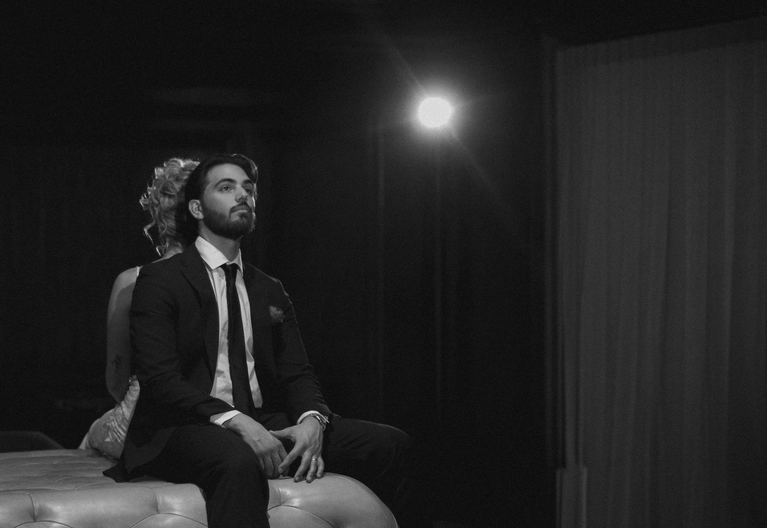 Tyler Garlej Photography - A series of black and white film stills showing a person in a suit sitting at a desk in a dark office setting.