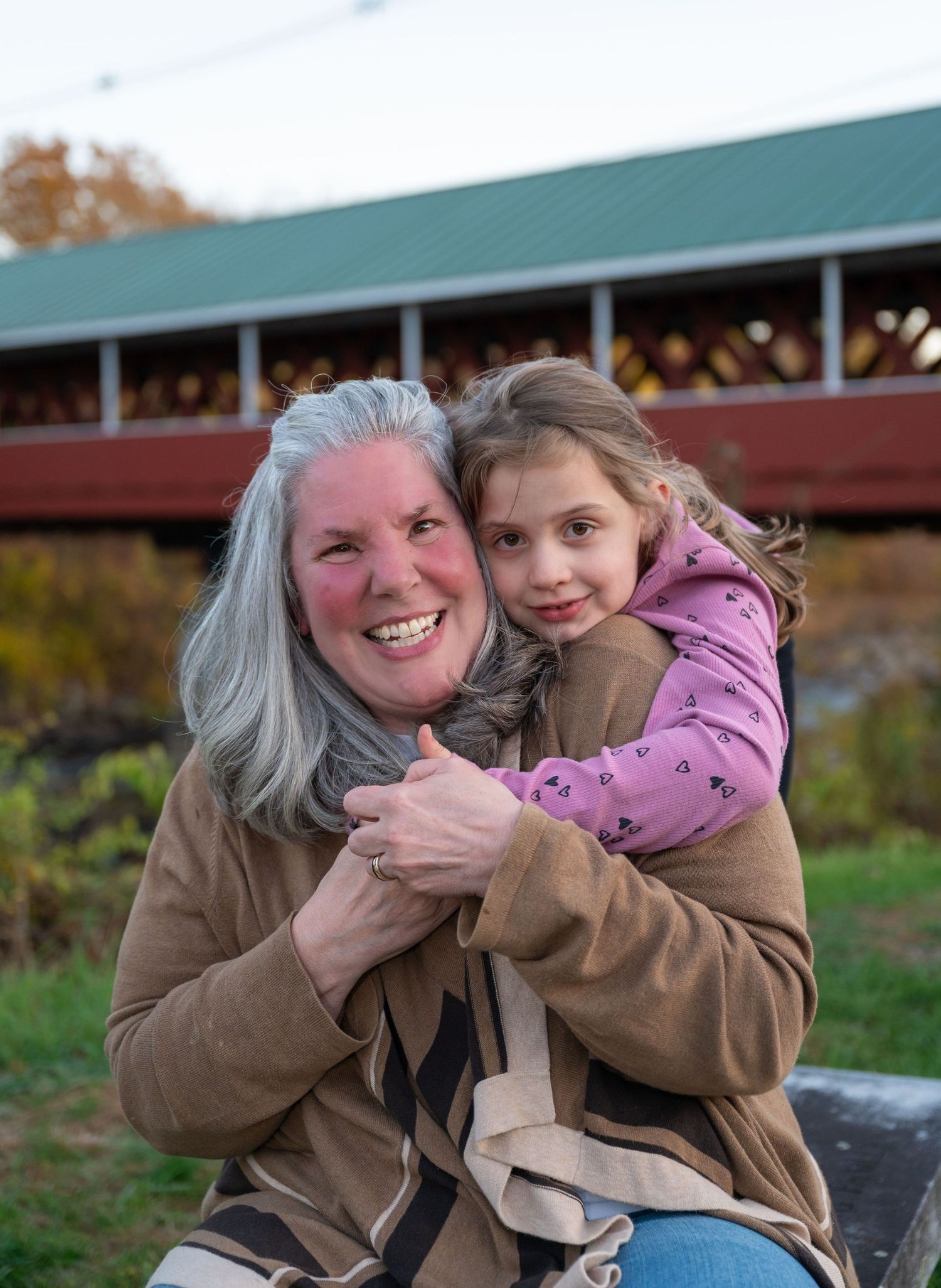 A true to color family portrait of a woman and her granddaughter