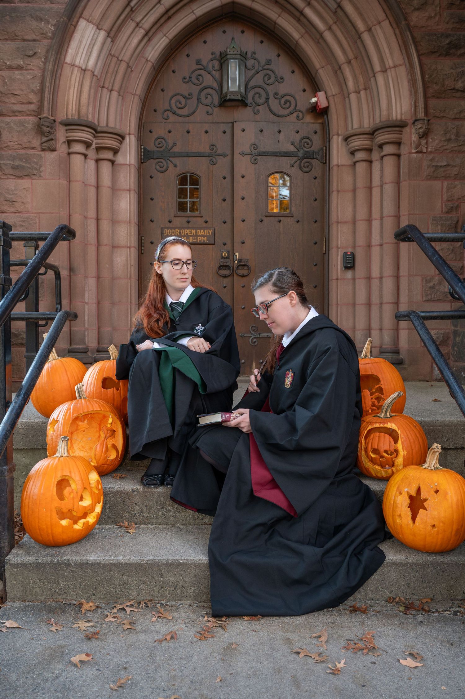 2 Woman dressed as Hogwarts students sitting together for a true to color photo at Mt. Holyoke College