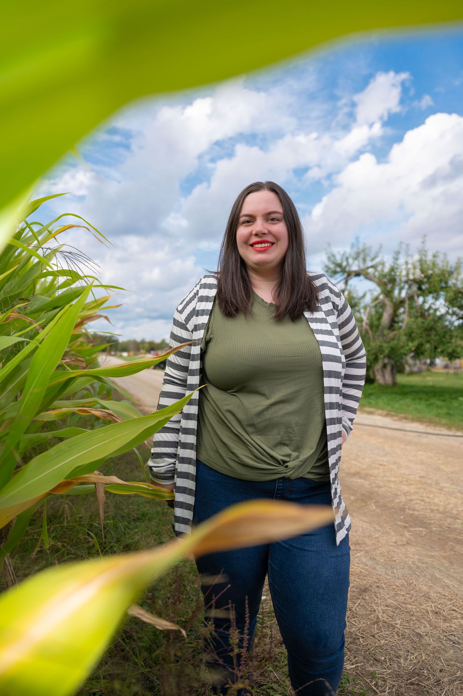 A woman posing next to a corn maze at Windy Hill Orchard in Greenville, New Hampshire