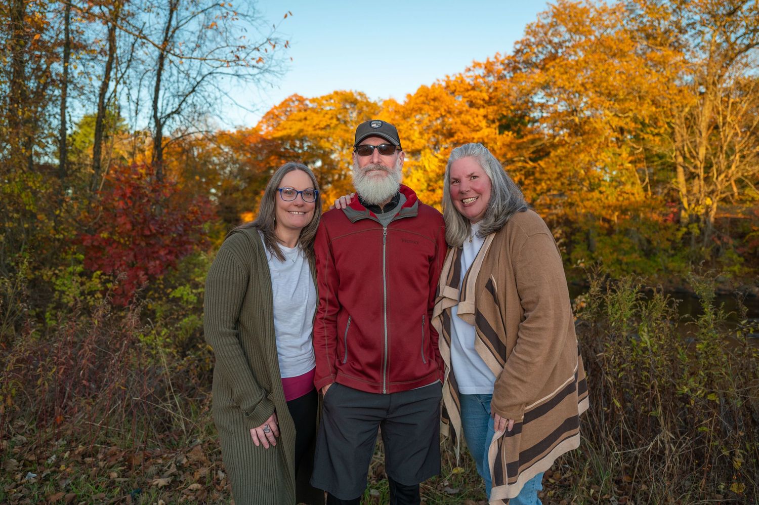 3 siblings posing for a true to color family portrait in Swanzey, New Hampshire
