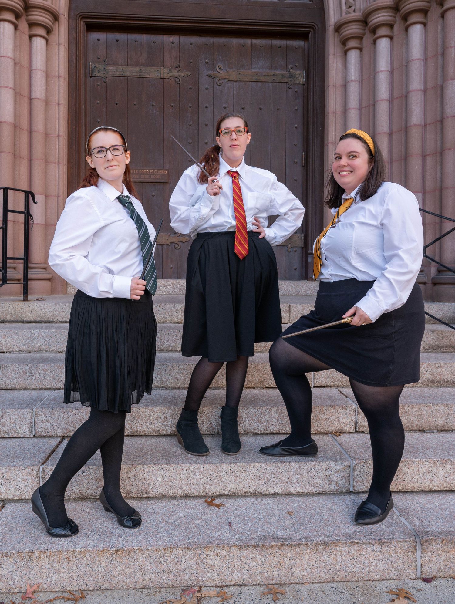 3 girls dressed in Hogwarts uniforms pose for a true to color photo at Mt. Holyoke College.