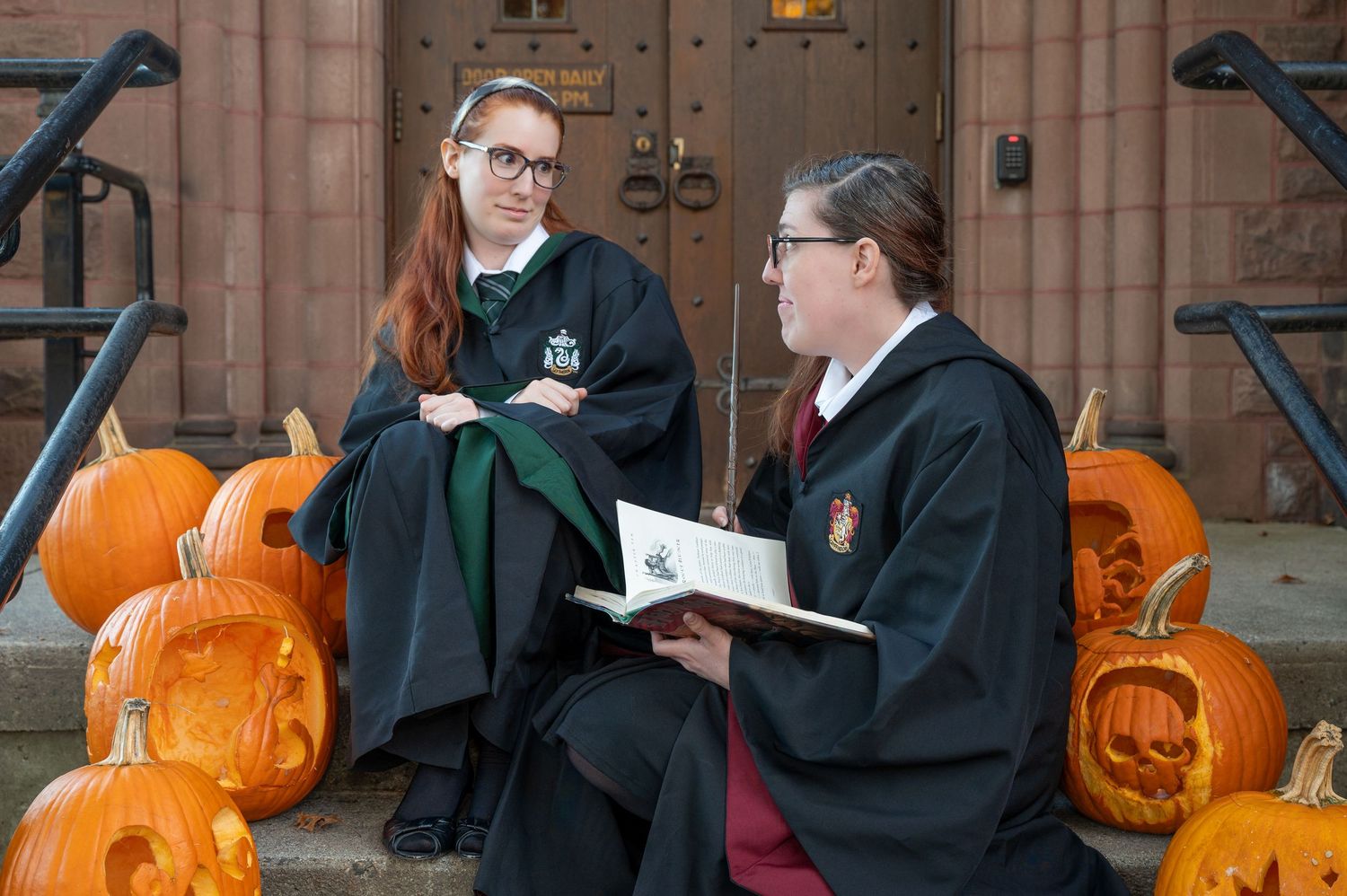 A group of friends dressed as Hogwarts students from Harry Potter pose for a photo at Mt. Holyoke College.