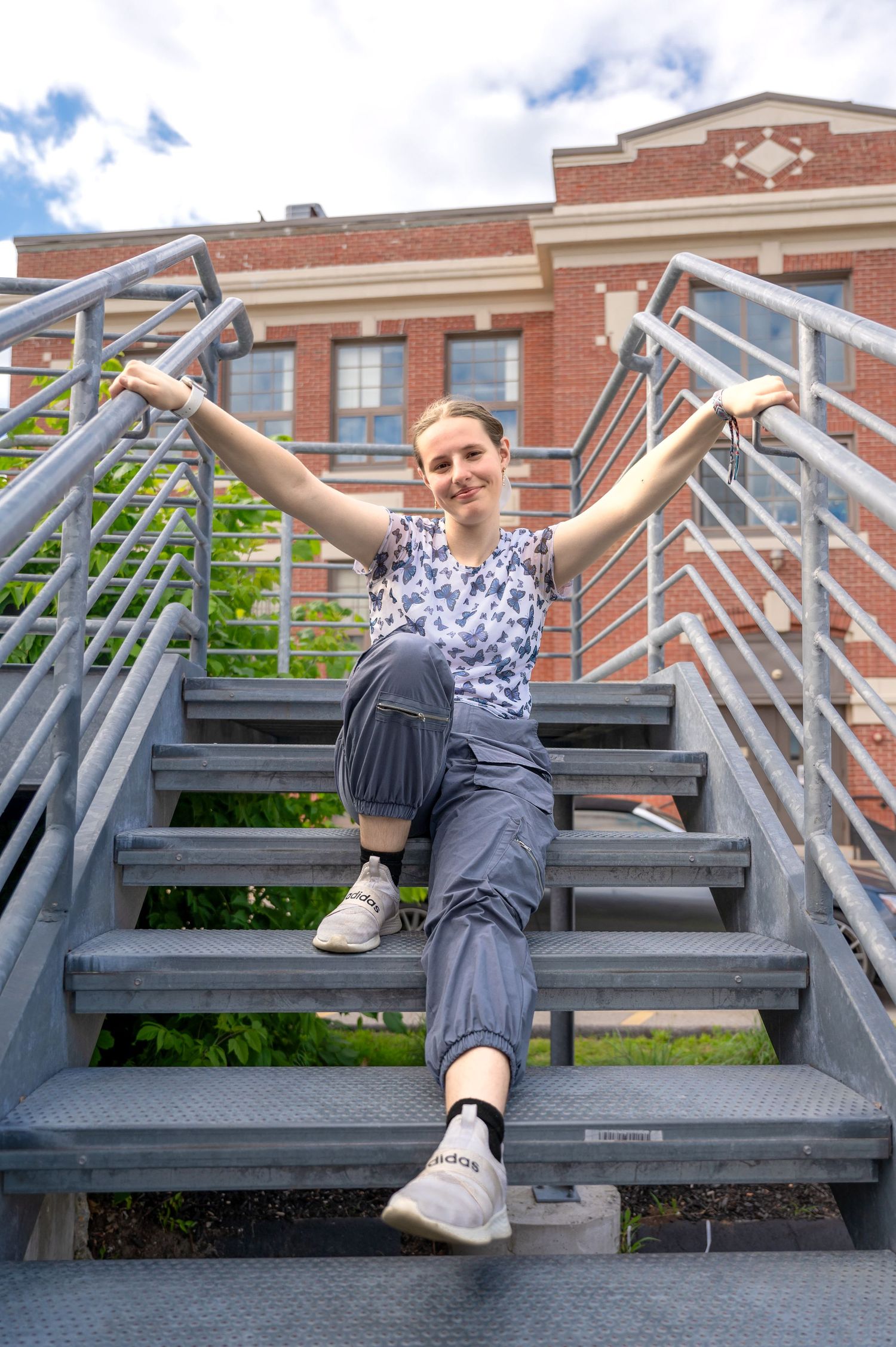 A girl posing on a staircase downtown in the city of Keene, New Hampshire.