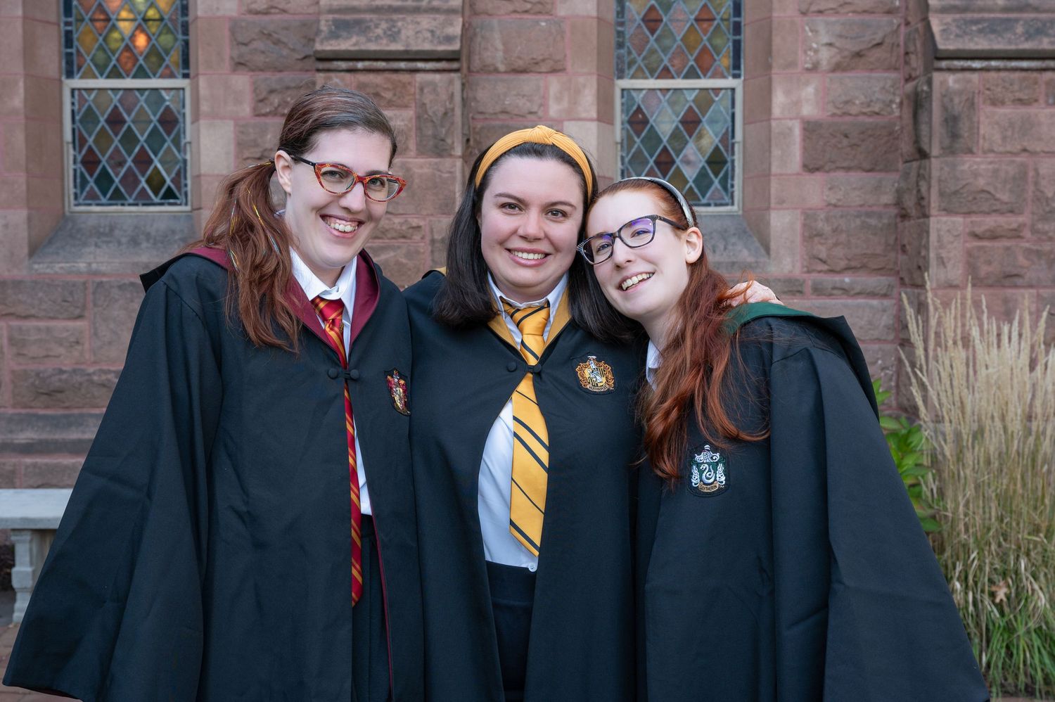 A group of friends dressed as Hogwarts students from Harry Potter pose for a photo at Mt. Holyoke College.
