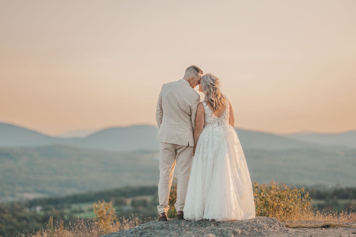 Sunset mountain wedding portrait in the White Mountains near Littleton, NH with golden hour light.
