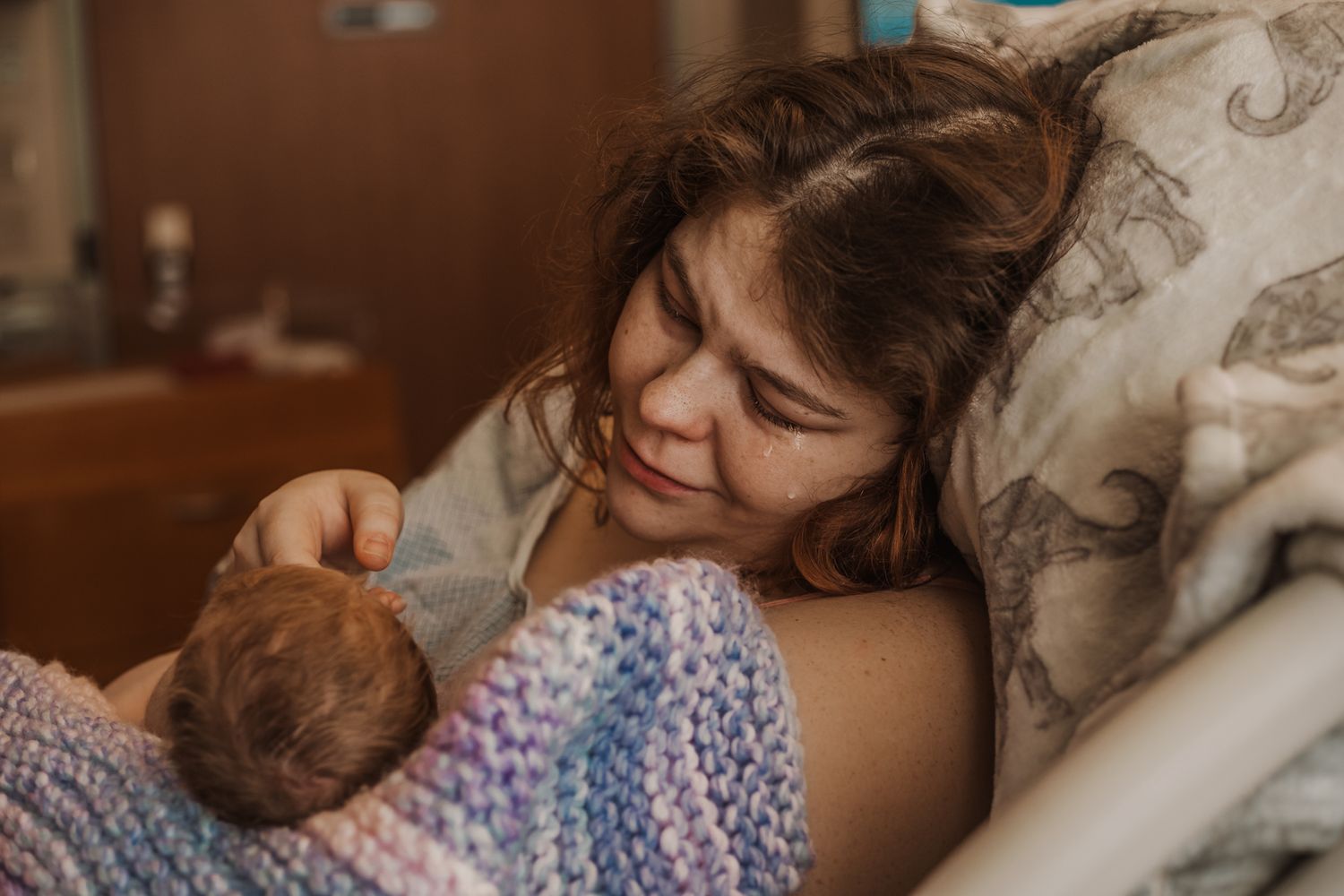 Birth photography session in Littleton, New Hampshire documenting emotional moments during labor and delivery.